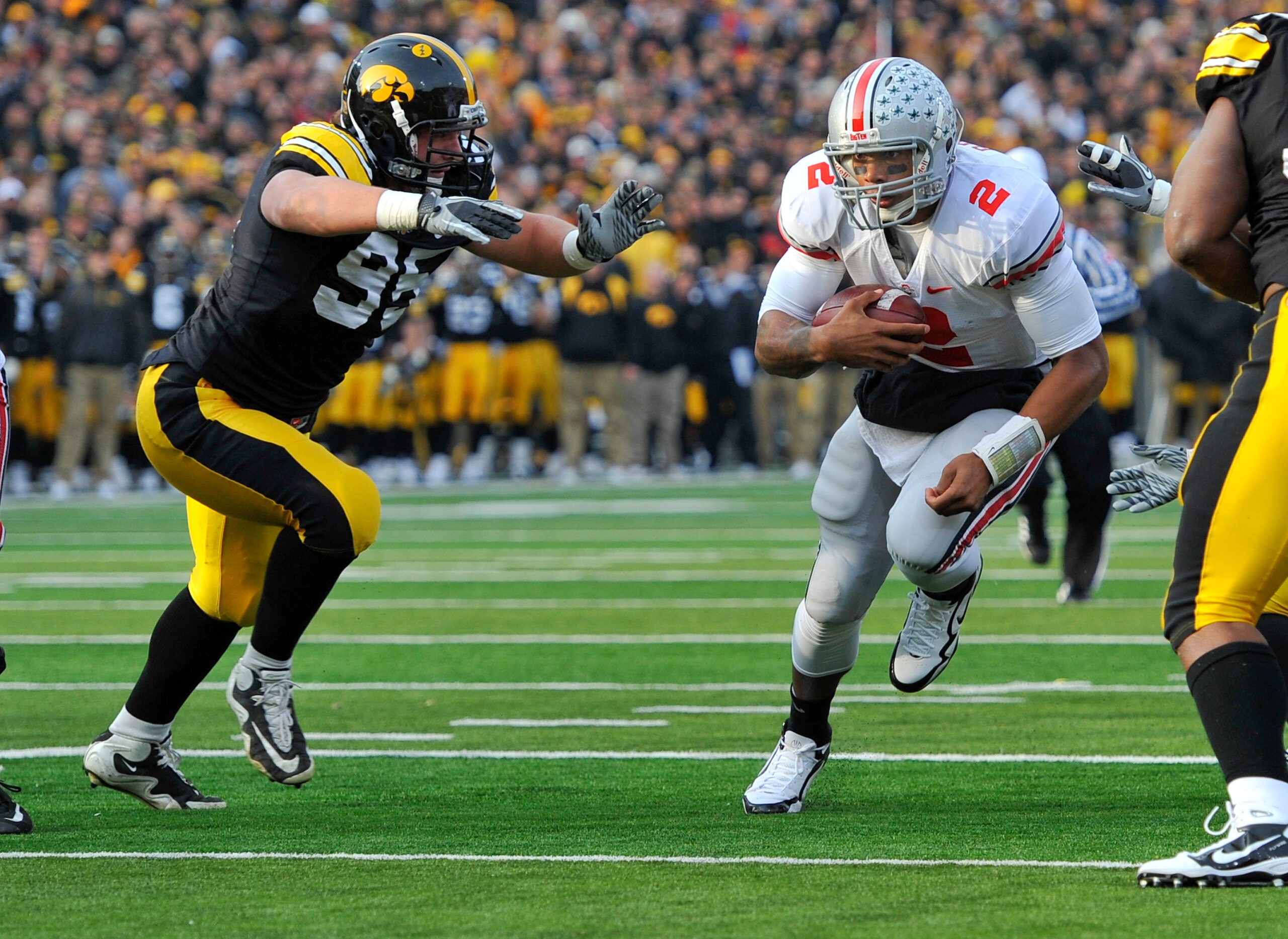IOWA CITY, IA - NOVEMBER 20: Defeisive lineman Karl Klug #95 of the University of Iowa Hawkeyes close in for the tackle on quarterback Terrelle Pryor #2 of the Ohio State Buckeyes as he drive the ball towards the goal line during the first half of play a IOWA CITY, IA - NOVEMBER 20: Defeisive lineman Karl Klug #95 of the University of Iowa Hawkeyes close in for the tackle on quarterback Terrelle Pryor #2 of the Ohio State Buckeyes as he drive the ball towards the goal line during the first half of play a