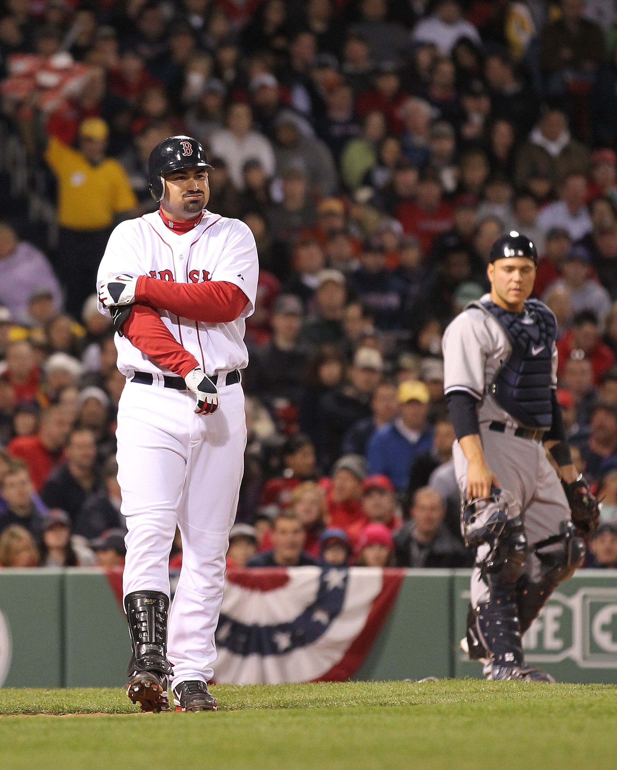 BOSTON, MA - APRIL 10:  Adrian Gonzalez #28 of the Boston Red Sox reacts after being hit by a pitch against the New York Yankees at Fenway Park April 10, 2011 in Boston, Massachusetts. (Photo by Jim Rogash/Getty Images)