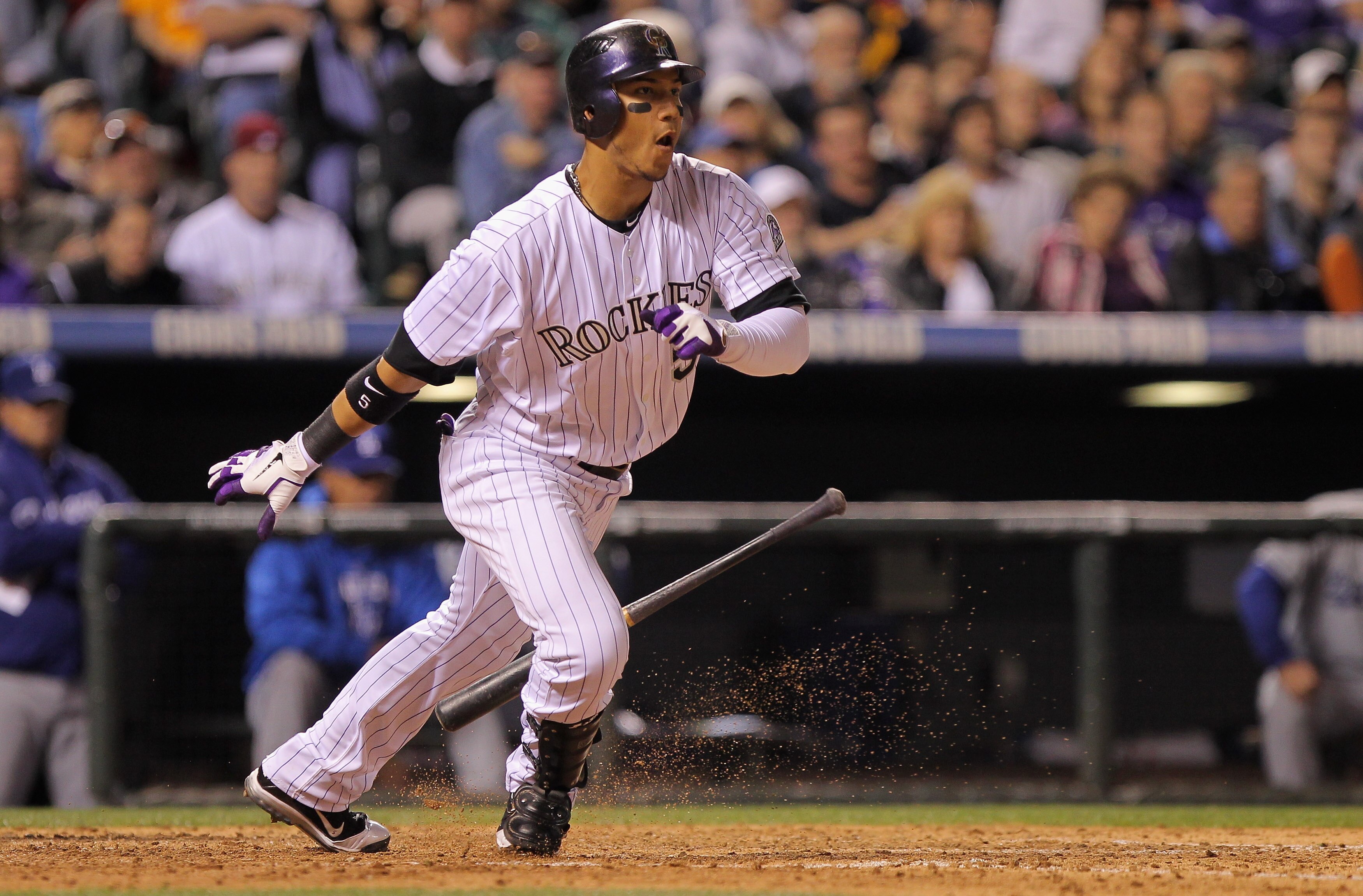 DENVER, CO - APRIL 05:  Carlos Gonzalez #5 of the Colorado Rockies takes an at bat against the Los Angeles Dodgers at Coors Field on April 5, 2011 in Denver, Colorado.  (Photo by Doug Pensinger/Getty Images)