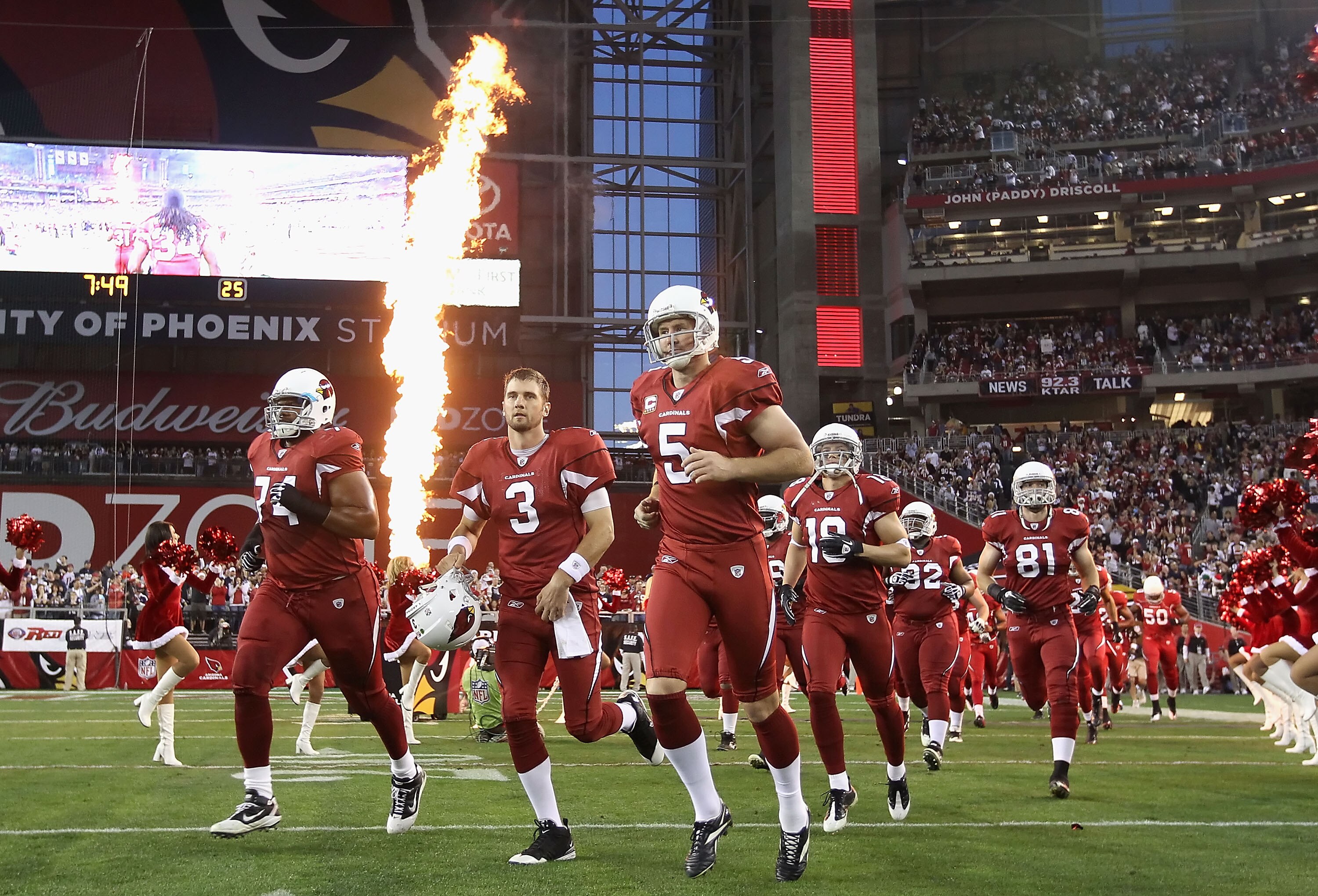 GLENDALE, AZ - DECEMBER 25:  (L-R) D'Anthony Batiste #74, Derek Anderson #3 and Ben Graham #5 of the Arizona Cardinals run out onto the field before the NFL game against the Dallas Cowboys at the University of Phoenix Stadium on December 25, 2010 in Glend