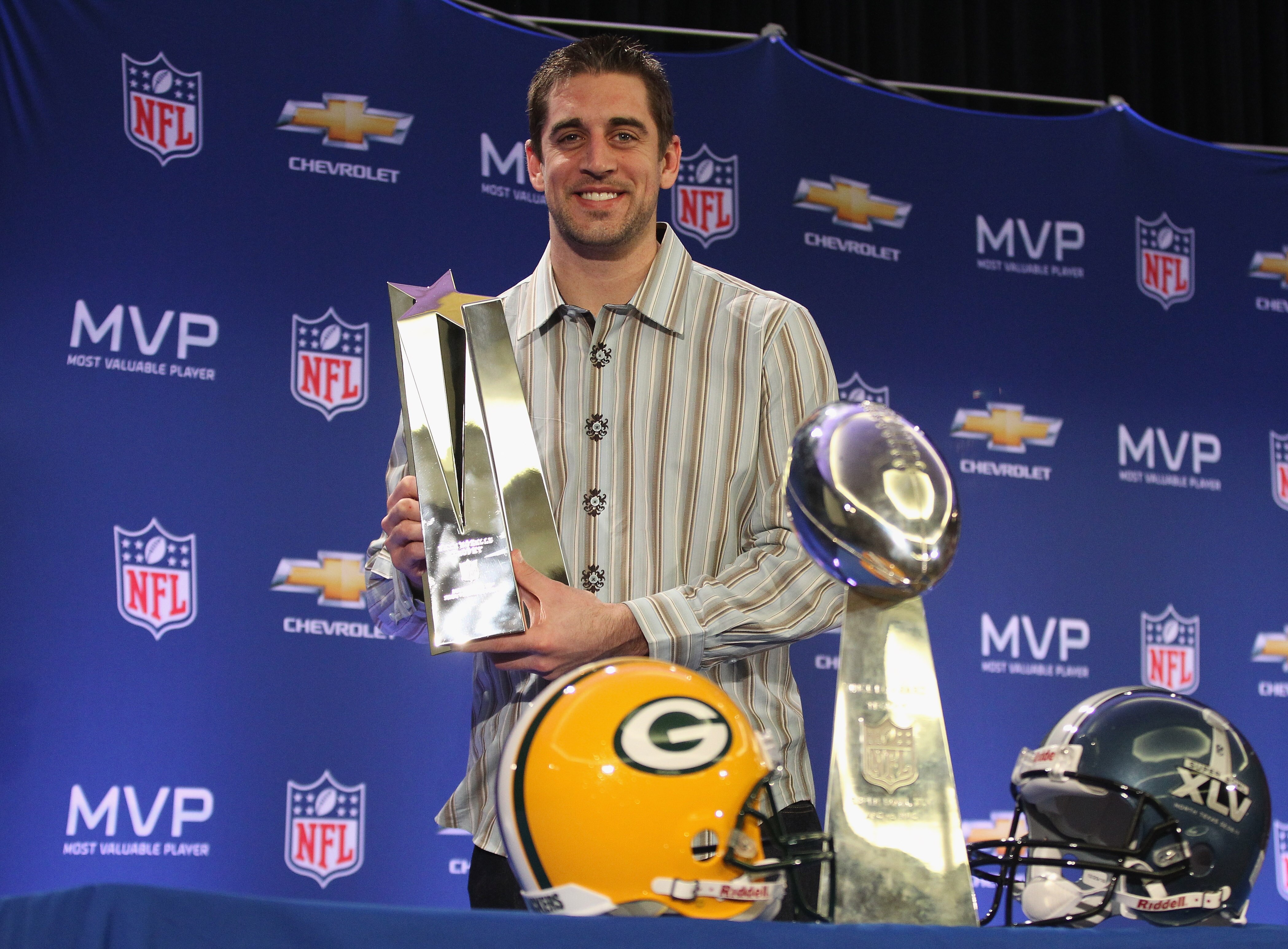 DALLAS, TX - FEBRUARY 07:  Green Bay Packers quarterback Aaron Rodgers poses with the MVP trophy after speaking to the media during a press conference at Super Bowl XLV Media Center on February 7, 2011 in Dallas, Texas.  (Photo by Streeter Lecka/Getty Ima