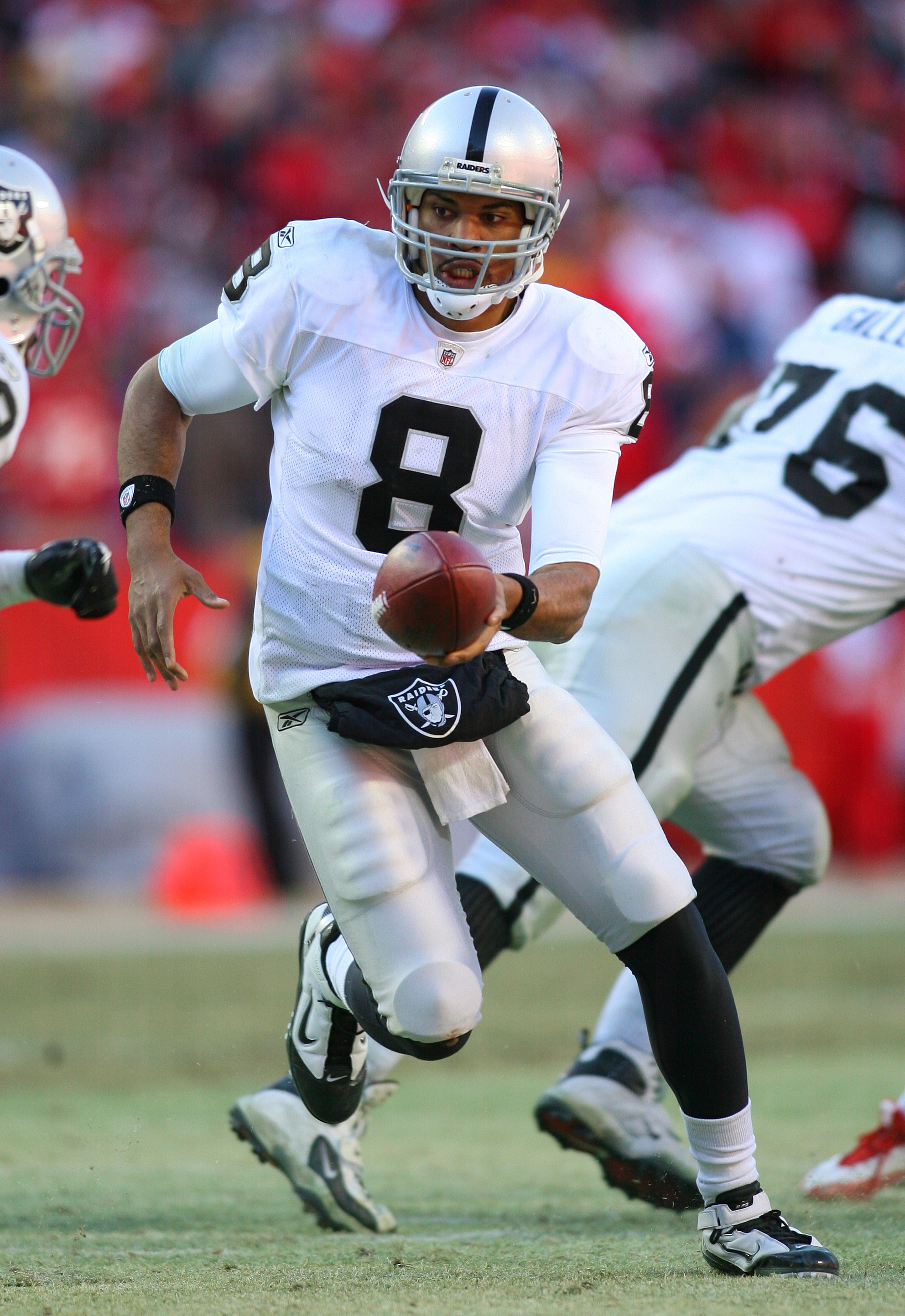 KANSAS CITY, MO - JANUARY 02:  Quarterback Jason Campbell #8 of the Oakland Raiders hands off to the running back in a game against the Kansas City Chiefs at Arrowhead Stadium on January 2, 2011 in Kansas City, Missouri.  (Photo by Tim Umphrey/Getty Image