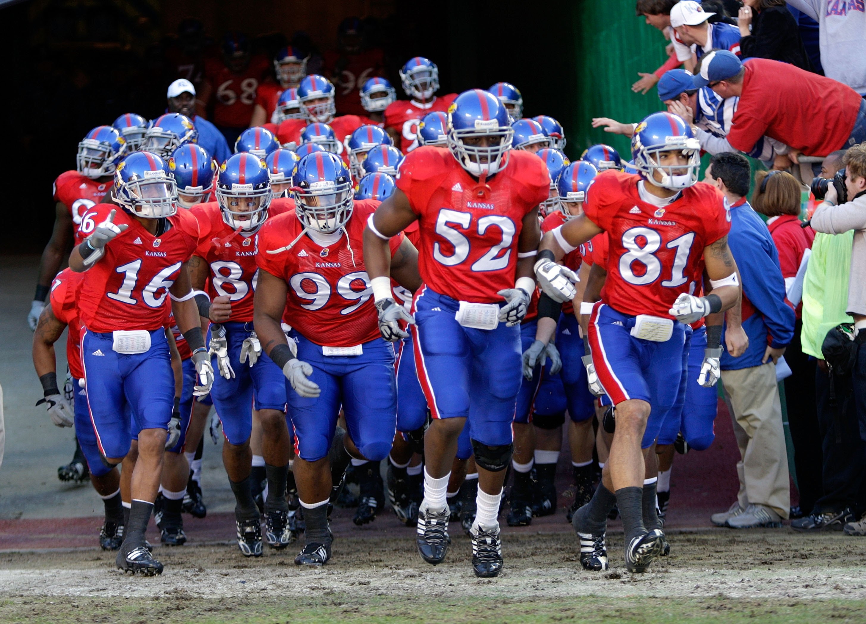 KANSAS CITY, MO - NOVEMBER 28:  Members of the Kansas Jayhawks run onto the field prior to their game against the Missouri Tigers during the game at Arrowhead Stadium on November 28, 2009 in Kansas City, Missouri. (Photo by Jamie Squire/Getty Images)