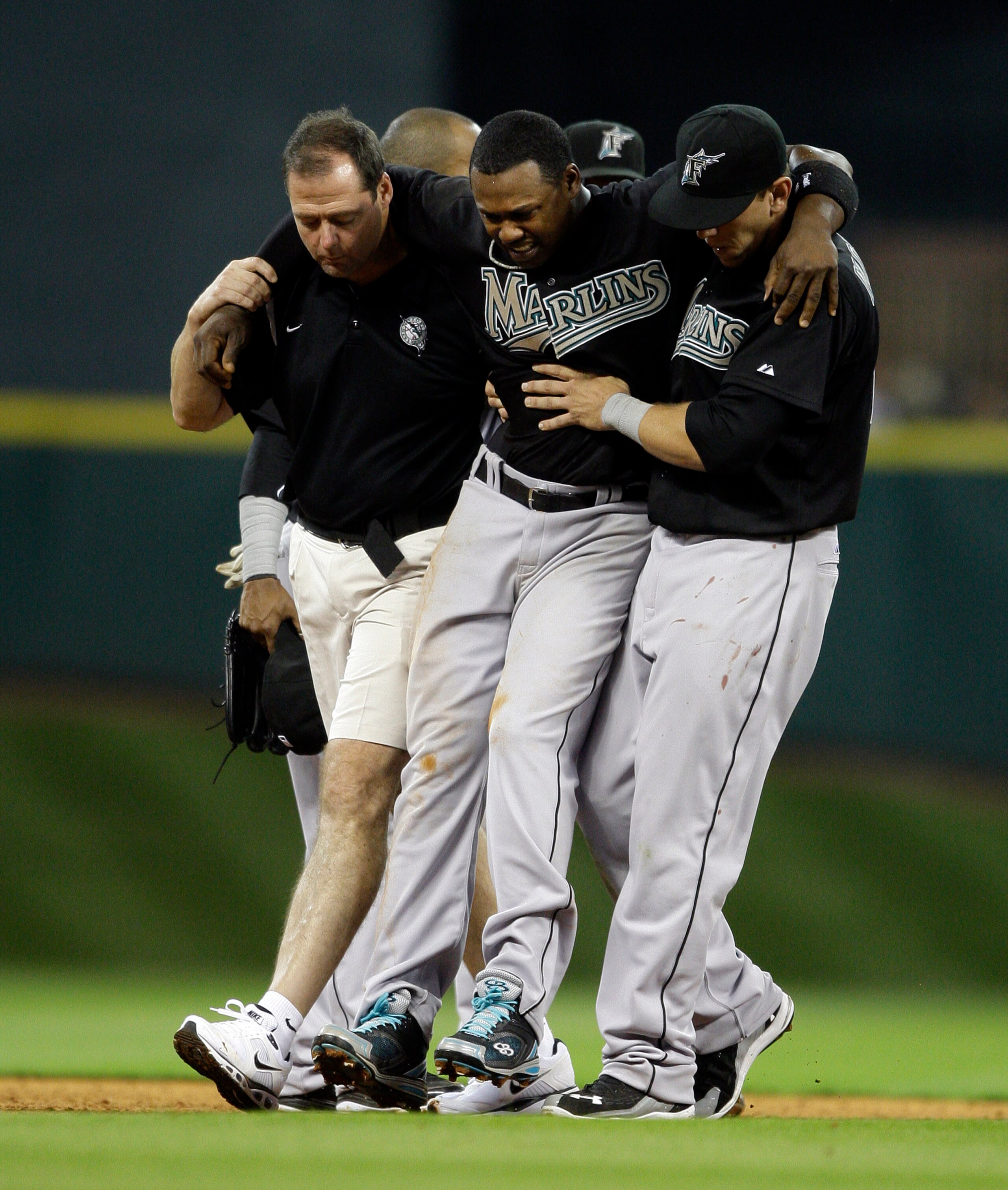HOUSTON - APRIL 08:  Shortstop Hanley Ramirez #2 of the Florida Marlins has to be helped off the field after Bill Hall #22 of the Houston Asrtros slid into second base to interupt the double play at Minute Maid Park on April 8, 2011 in Houston, Texas.  (P