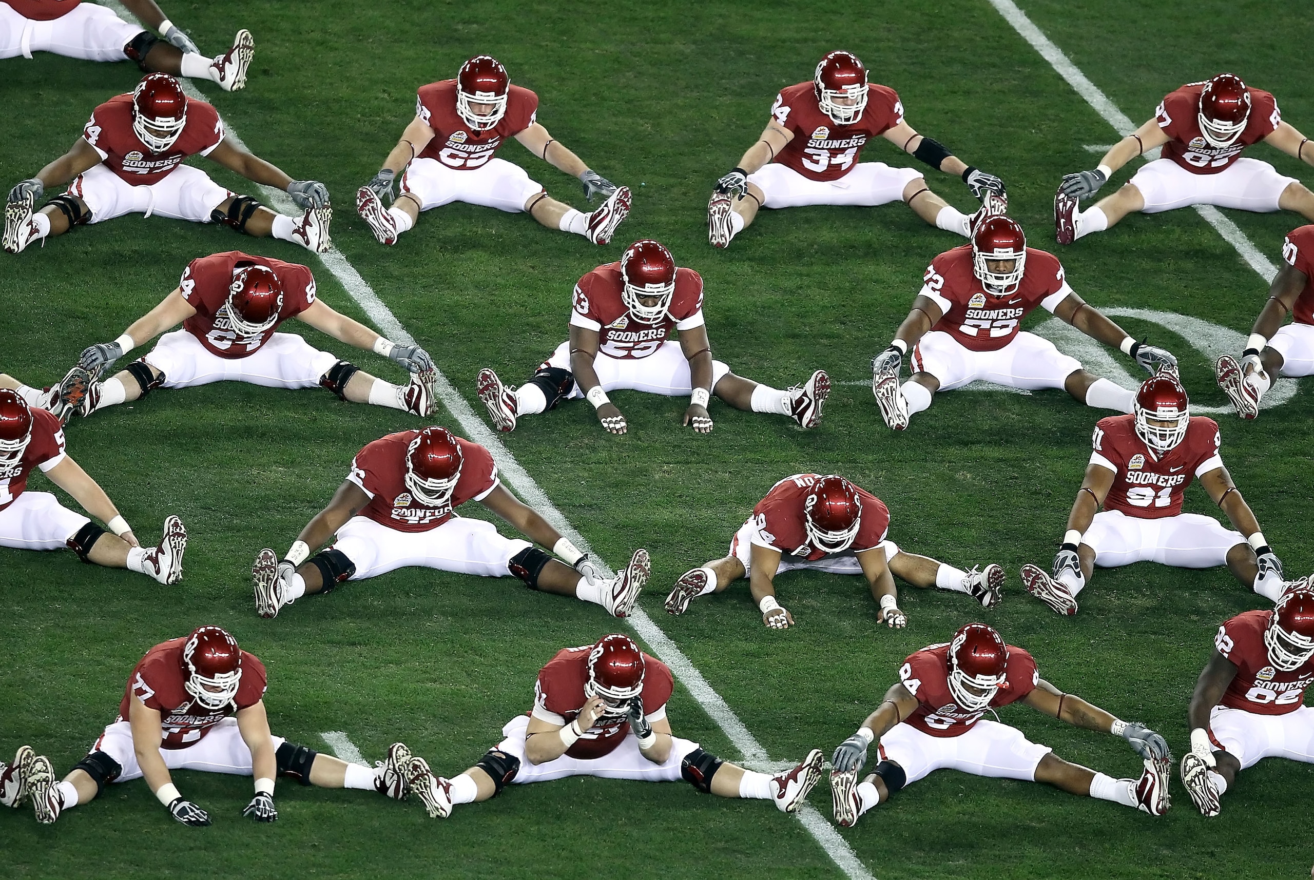 GLENDALE, AZ - JANUARY 01: The Oklahoma Sooners warm up before the Tostitos Fiesta Bowl against the Connecticut Huskies at the Universtity of Phoenix Stadium on January 1, 2011 in Glendale, Arizona. (Photo by Christian Petersen/Getty Images) GLENDALE, AZ - JANUARY 01: The Oklahoma Sooners warm up before the Tostitos Fiesta Bowl against the Connecticut Huskies at the Universtity of Phoenix Stadium on January 1, 2011 in Glendale, Arizona. (Photo by Christian Petersen/Getty Images)