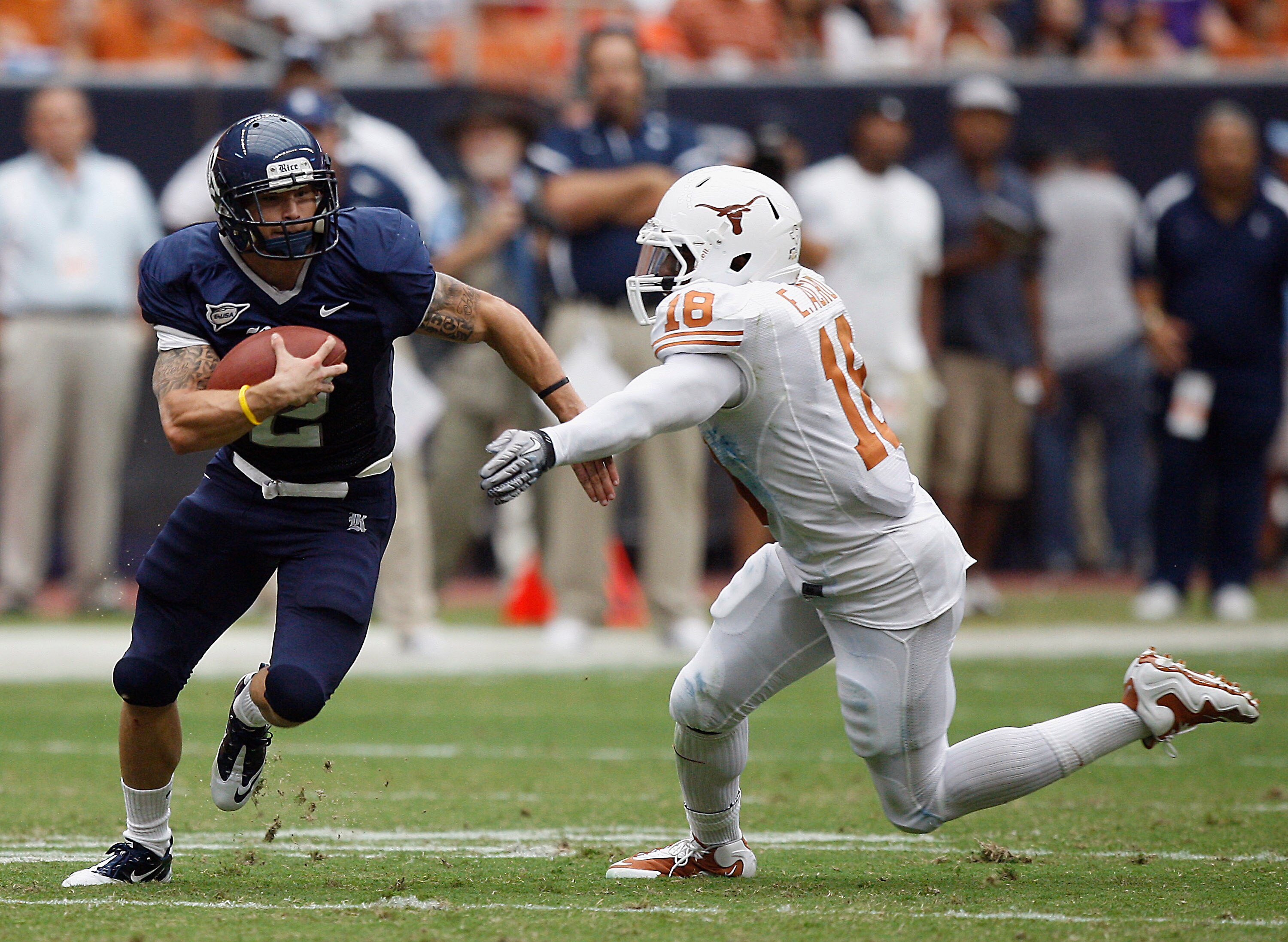 HOUSTON - SEPTEMBER 04:  Running back Sam McGuffie #2 of the Rice Owls rushes past safety Kenny Vaccaro #16 of the Texas Longhorns at Reliant Stadium on September 4, 2010 in Houston, Texas.  (Photo by Bob Levey/Getty Images)