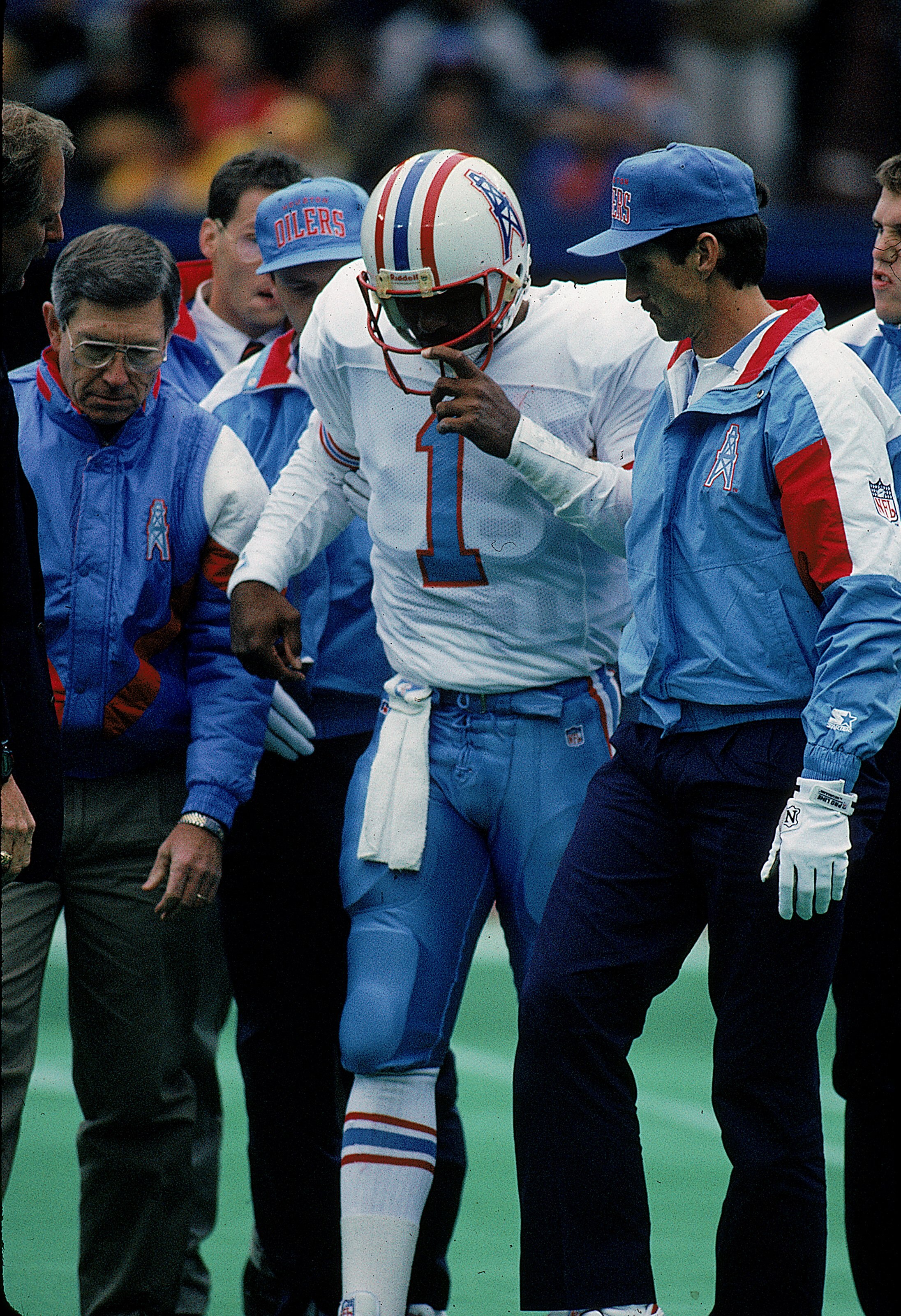 4 Nov 1992:  Quarterback Warren Moon #1 of the Oilers is injured during a game and helped off the field. Mandatory Credit: Jonathan Daniel  /Allsport