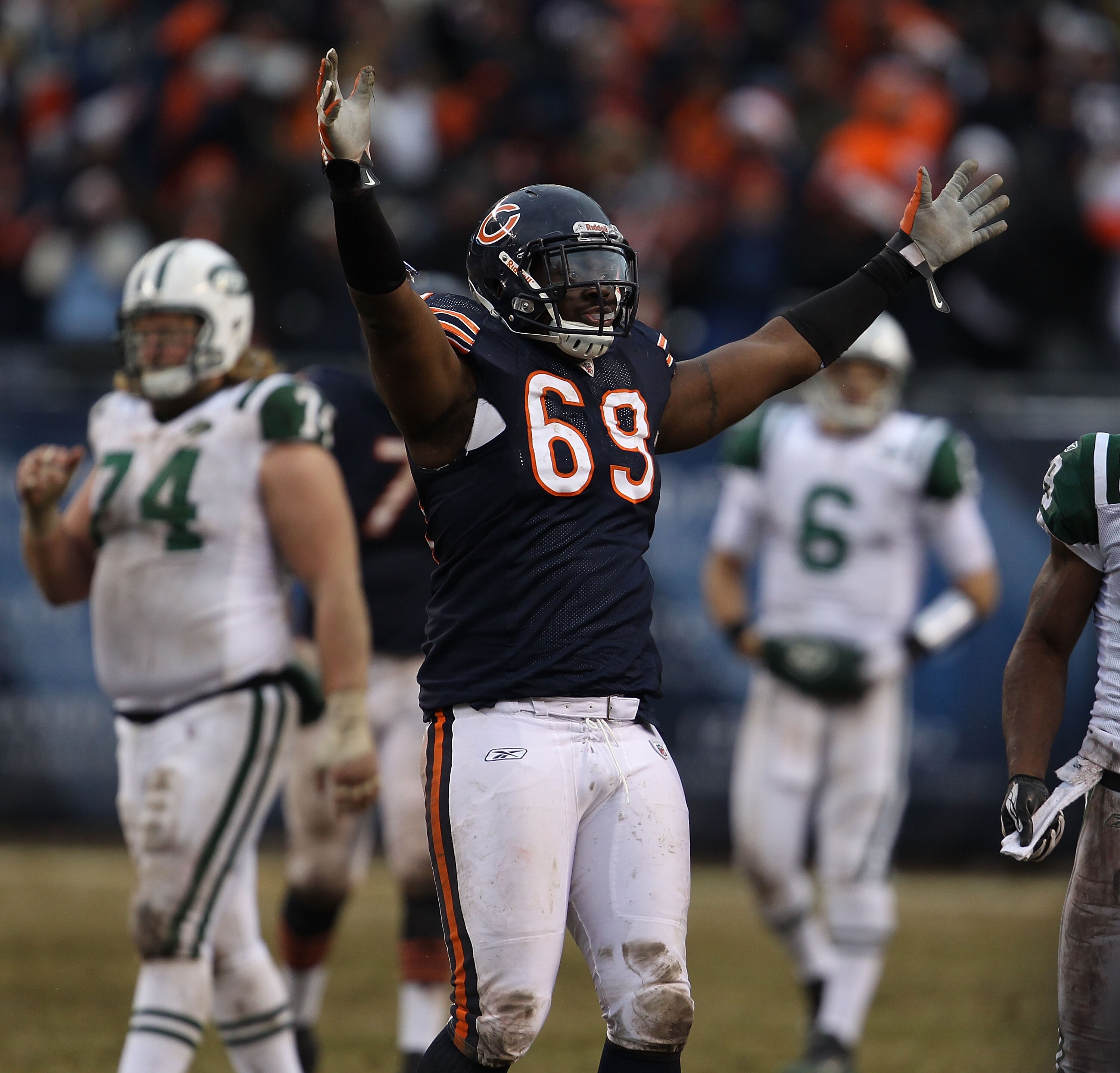 CHICAGO, IL - DECEMBER 26: Henry Melton #69 of the Chicago Bears celebrates after teammate Chris Harris intercepted a pass in the final minutes as Nick Mangold #74 and Mark Sanchez #6 of the New York Jets walk off of the field at Soldier Field on December CHICAGO, IL - DECEMBER 26: Henry Melton #69 of the Chicago Bears celebrates after teammate Chris Harris intercepted a pass in the final minutes as Nick Mangold #74 and Mark Sanchez #6 of the New York Jets walk off of the field at Soldier Field on December