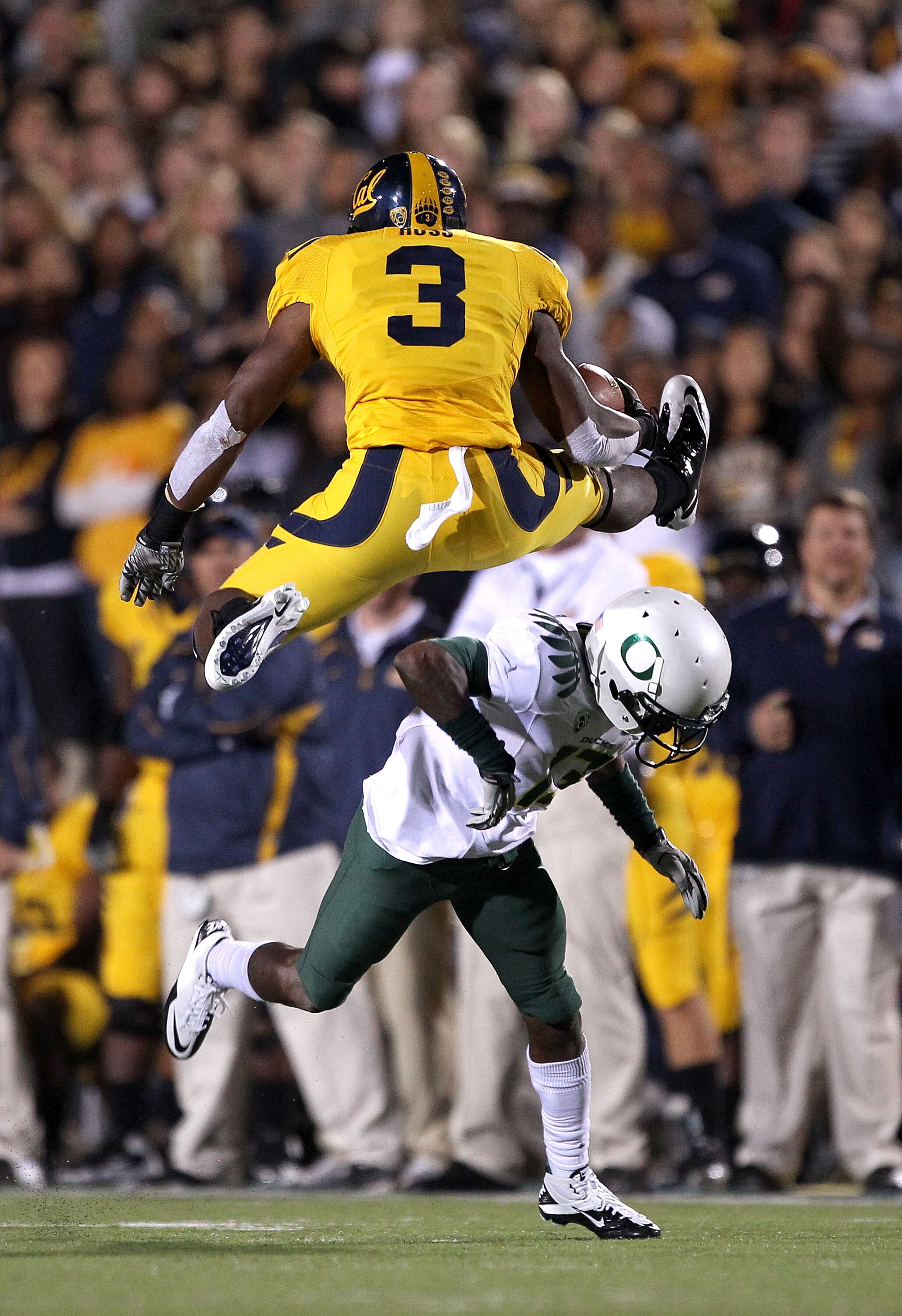 BERKELEY, CA - NOVEMBER 13:  Jeremy Ross #3 of the California Golden Bears jumps over Cliff Harris #13 of the Oregon Ducks at California Memorial Stadium on November 13, 2010 in Berkeley, California. (Photo by Ezra Shaw/Getty Images)