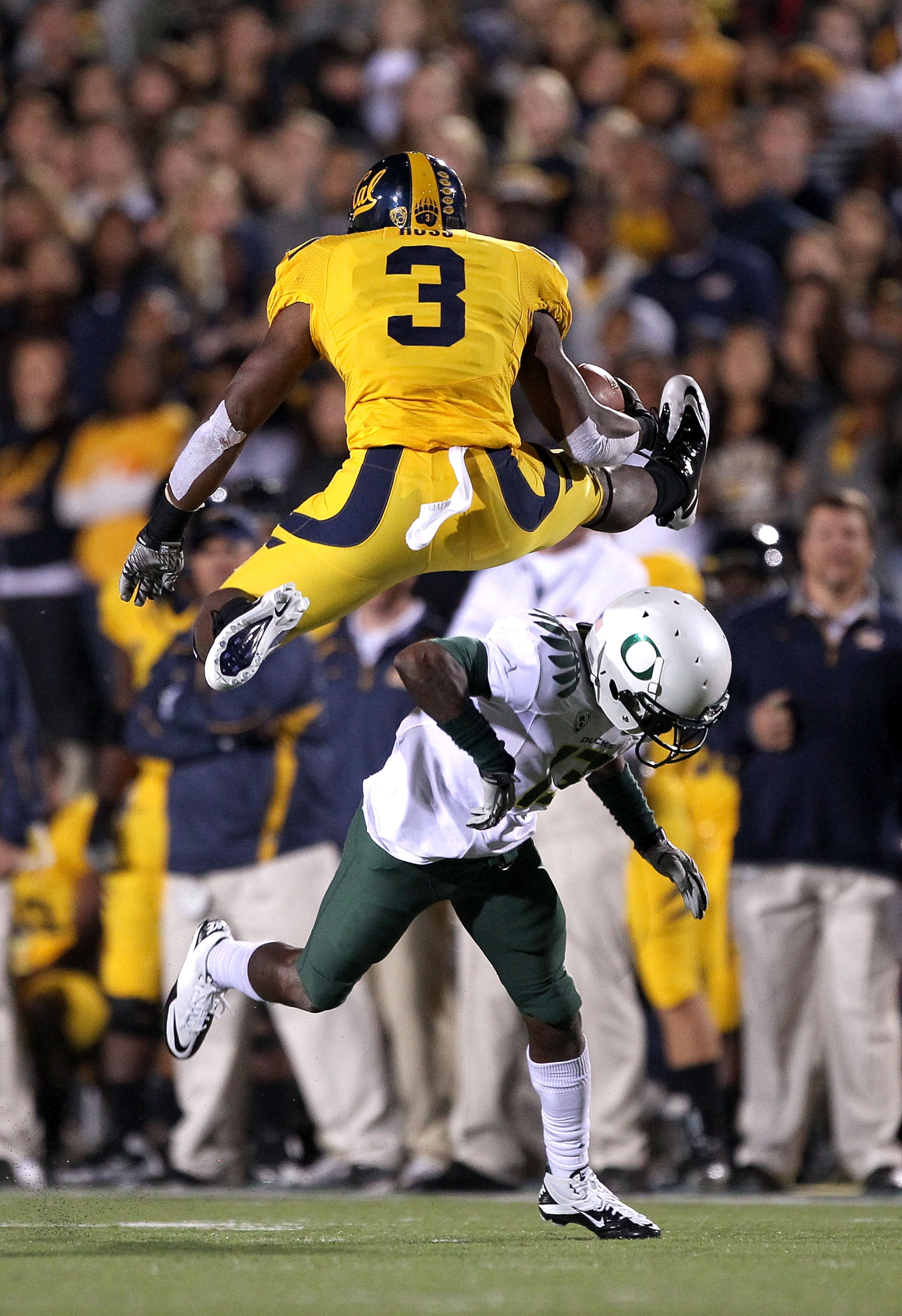 BERKELEY, CA - NOVEMBER 13:  Jeremy Ross #3 of the California Golden Bears jumps over Cliff Harris #13 of the Oregon Ducks at California Memorial Stadium on November 13, 2010 in Berkeley, California. (Photo by Ezra Shaw/Getty Images)
