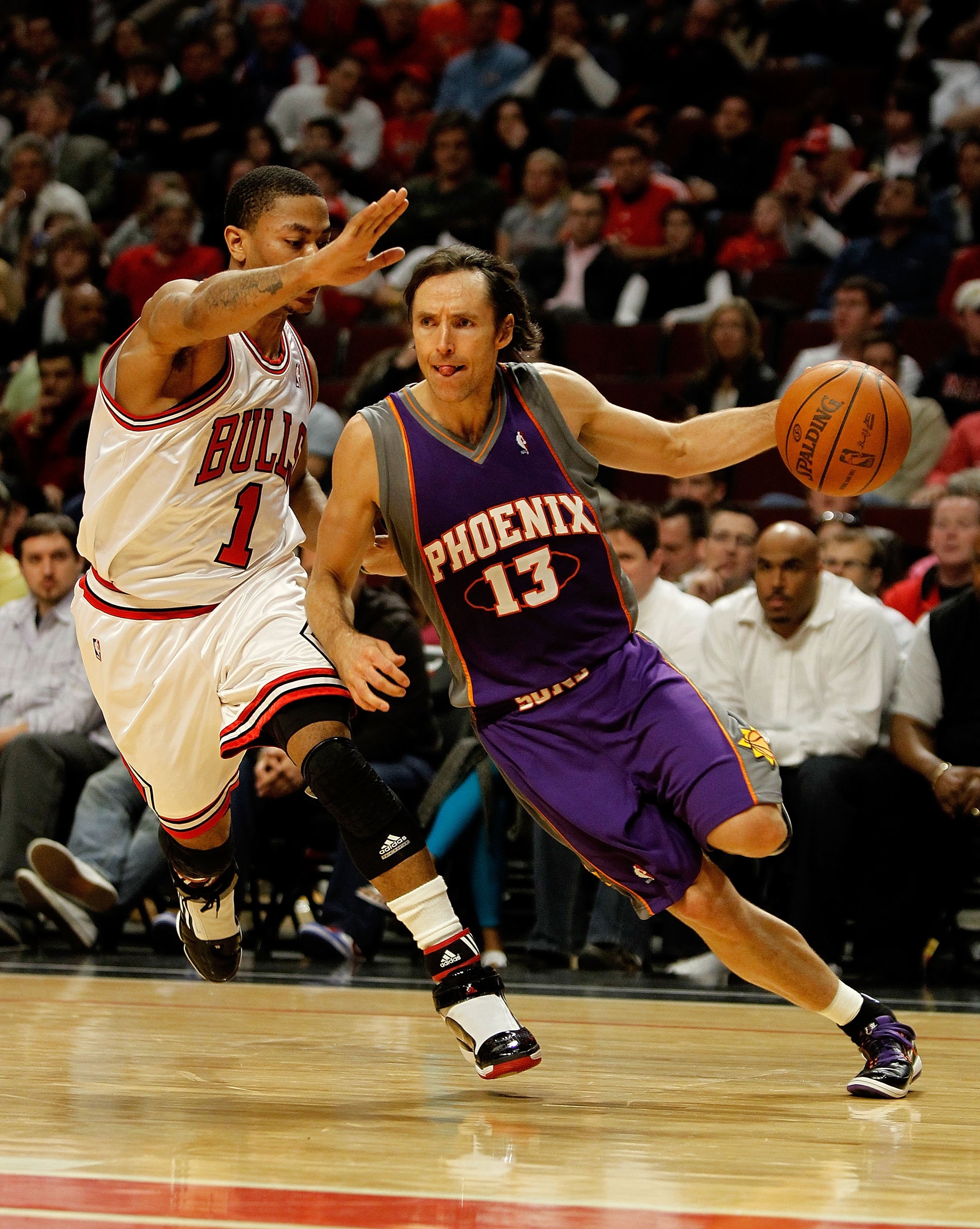 CHICAGO - MARCH 30: Steve Nash #13 of the Phoenix Suns drives around Derrick Rose #1 of the Chicago Bulls at the United Center on March 30, 2010 in Chicago, Illinois. The Suns defeated the Bulls 111-105. NOTE TO USER: User expressly acknowledges and agree