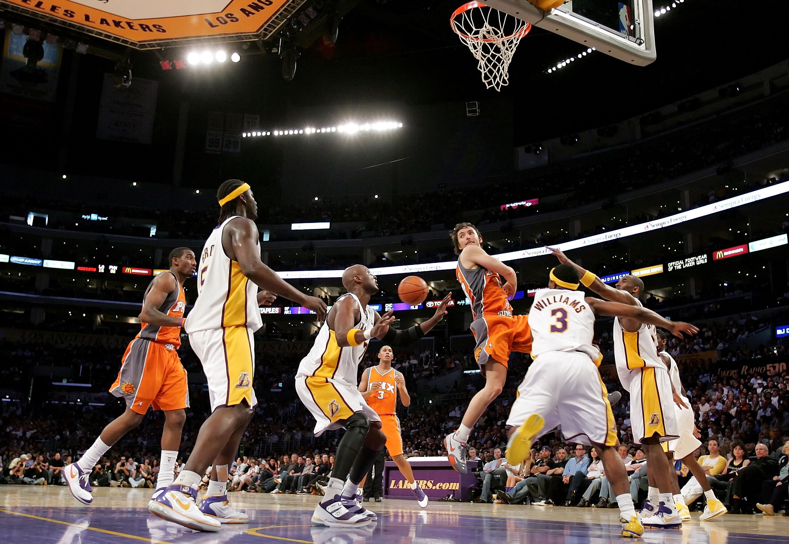 LOS ANGELES - APRIL 29:  Steve Nash #13 of the Phoenix Suns passes the ball behind his back under pressure from the Los Angeles Lakers in Game Four of the Western Conference Quarterfinals during the 2007 NBA Playoff at Staples Center on April 29, 2007 in