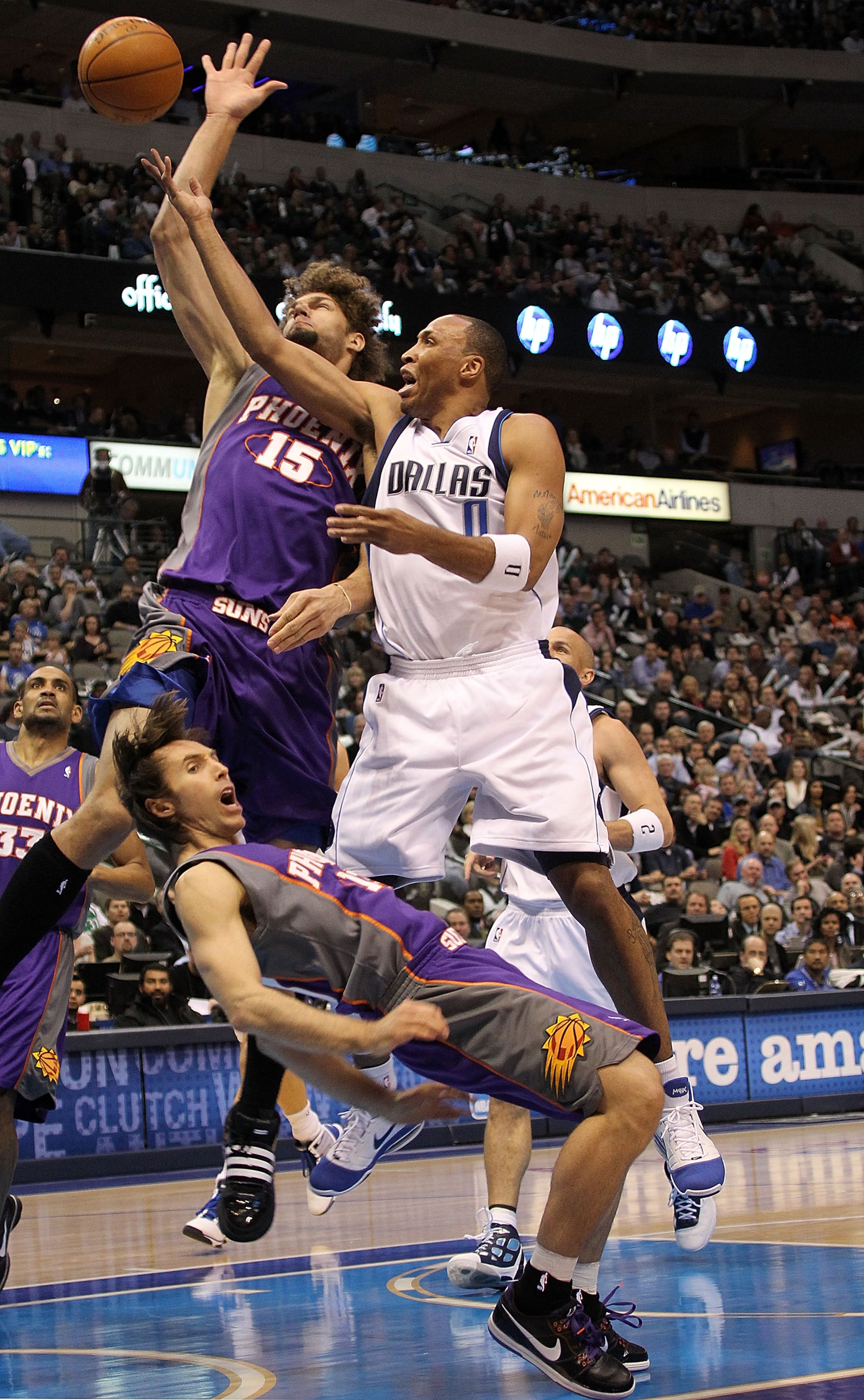 DALLAS - FEBRUARY 17:   Forward Shawn Marion #0 of the Dallas Mavericks fouls Steve Nash #13 of the Phoenix Suns on February 17, 2010 at American Airlines Center in Dallas, Texas.  NOTE TO USER: User expressly acknowledges and agrees that, by downloading
