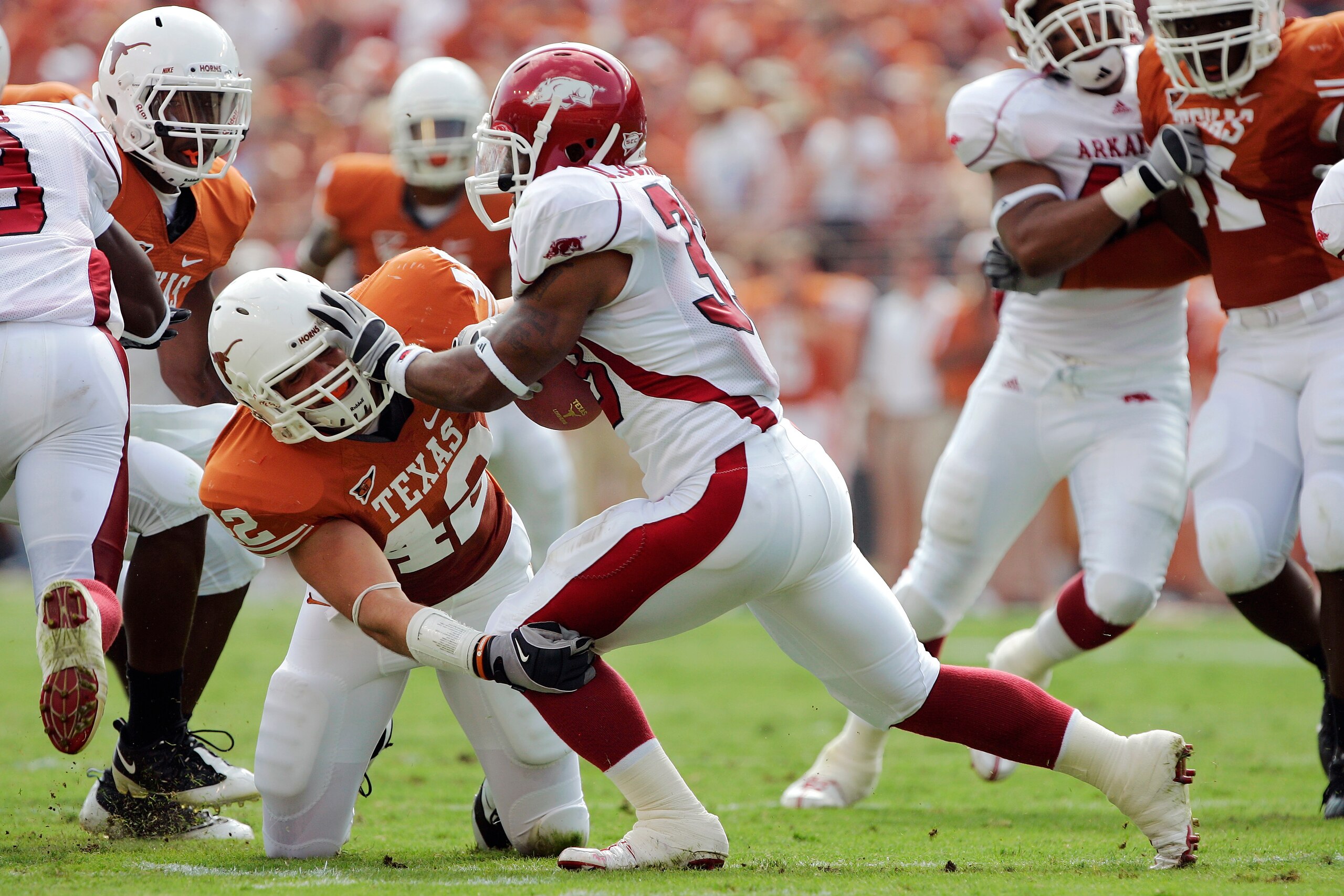 AUSTIN, TX - SEPTEMBER 27: Linebacker Dustin Earnest #42 of the Texas Longhorns wraps up tailback Dennis Johnson #33 of the Arkansas Razorbacks behind the line of scrimmage in the second quarter on September 27, 2008 at Darrell K Royal-Texas Memorial Stad