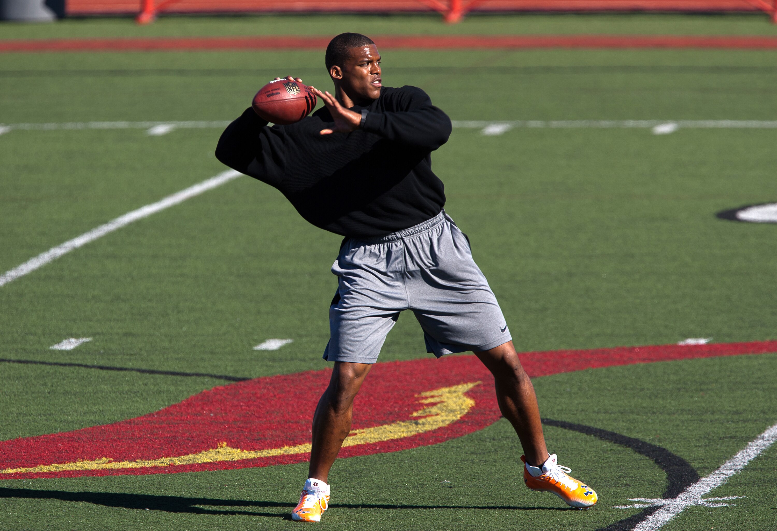 SAN DIEGO, CA - FEBRUARY 10: 2010 Heisman Trophy winning quarterback Cam Newton of Auburn throws the ball during his workout routine for the media at Cathedral High School's sports stadium on February 10, 2011 in San Diego, California. (Photo by Kent Horn