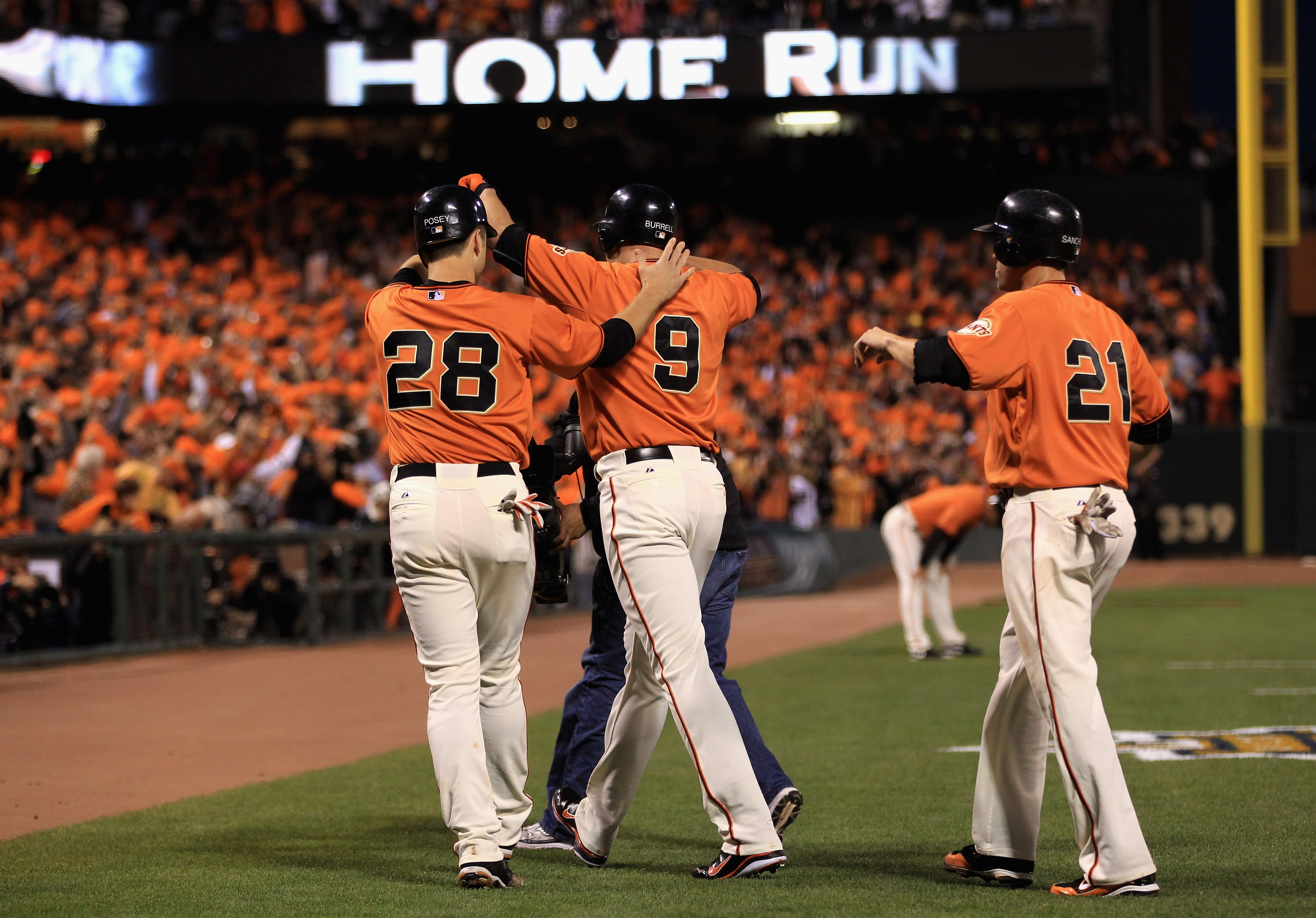 SAN FRANCISCO - OCTOBER 08:  Pat Burrell #9 is congratulated by Buster Posey #28 and Freddy Sanchez #21 of the San Francisco Giants after he hit a three run home run in the first inning against the Atlanta Braves in game 2 of the NLDS at AT&T Park on Octo