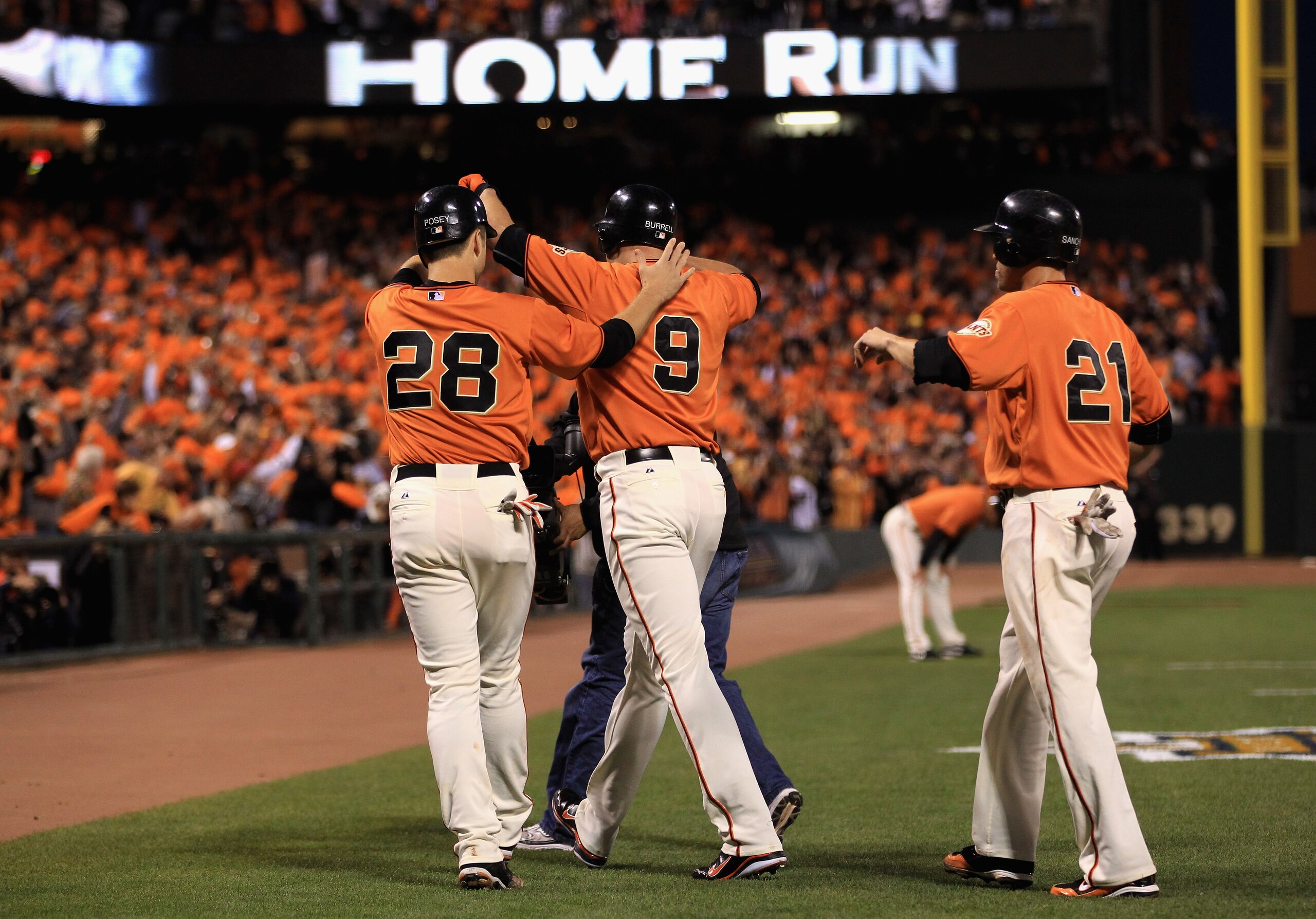 SAN FRANCISCO - OCTOBER 08:  Pat Burrell #9 is congratulated by Buster Posey #28 and Freddy Sanchez #21 of the San Francisco Giants after he hit a three run home run in the first inning against the Atlanta Braves in game 2 of the NLDS at AT&T Park on Octo