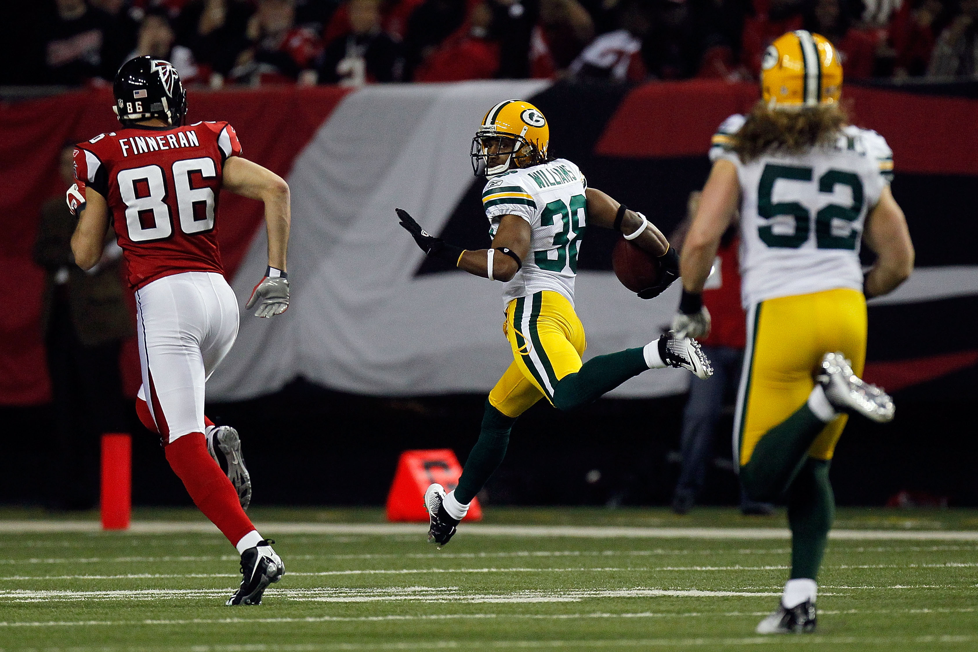 ATLANTA, GA - JANUARY 15:  Tramon Williams ##8 of the Green Bay Packers returns an interception 70-yards for a touchdown in the second quarter against the Atlanta Falcons during their 2011 NFC divisional playoff game at Georgia Dome on January 15, 2011 in