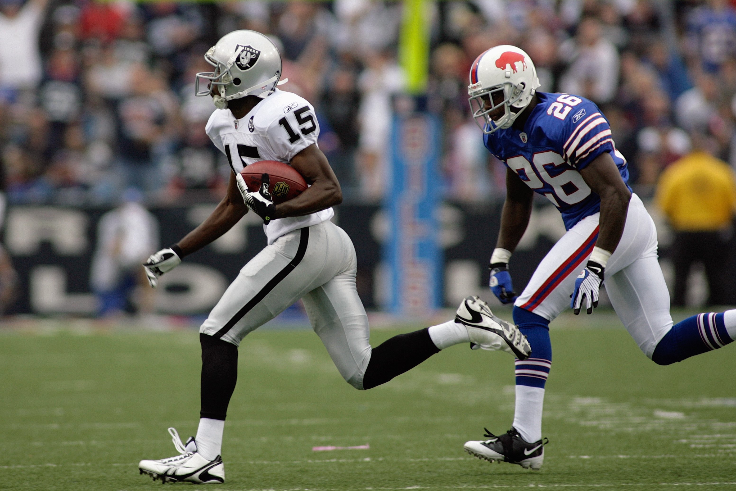 ORCHARD PARK, NY - SEPTEMBER 21:  Johnnie Lee Higgins #15 of the Oakland Raiders runs with the ball against Ashton Youboty #26 of the Buffalo Bills during the game on September 21, 2008 at Ralph Wilson Stadium in Orchard Park, New York. (Photo by Rick Ste