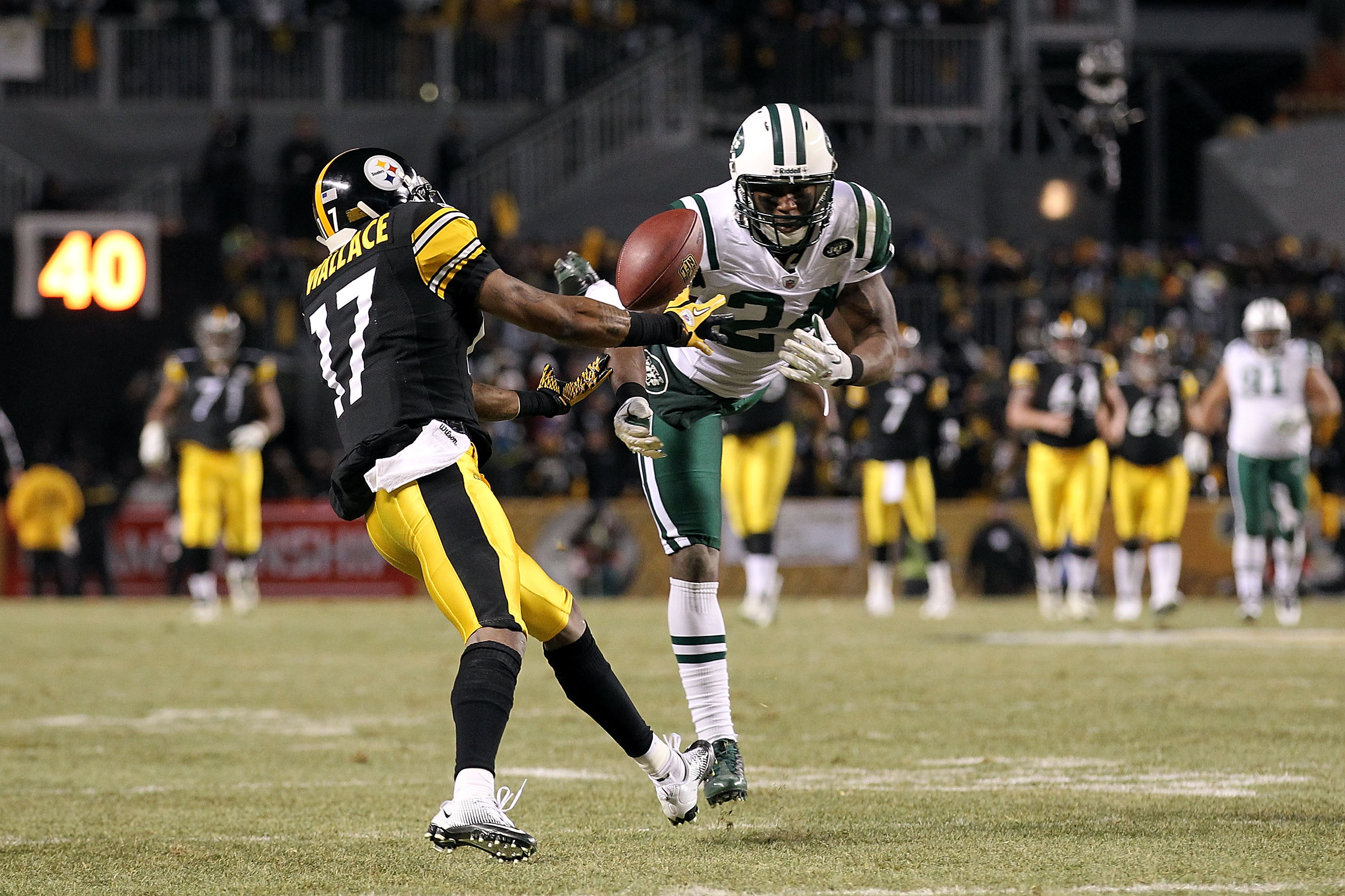 PITTSBURGH, PA - JANUARY 23:  Darrelle Revis #24 of the New York Jets breaks up a pass intended for Mike Wallace #17 of the Pittsburgh Steelers during the 2011 AFC Championship game at Heinz Field on January 23, 2011 in Pittsburgh, Pennsylvania. The Steel