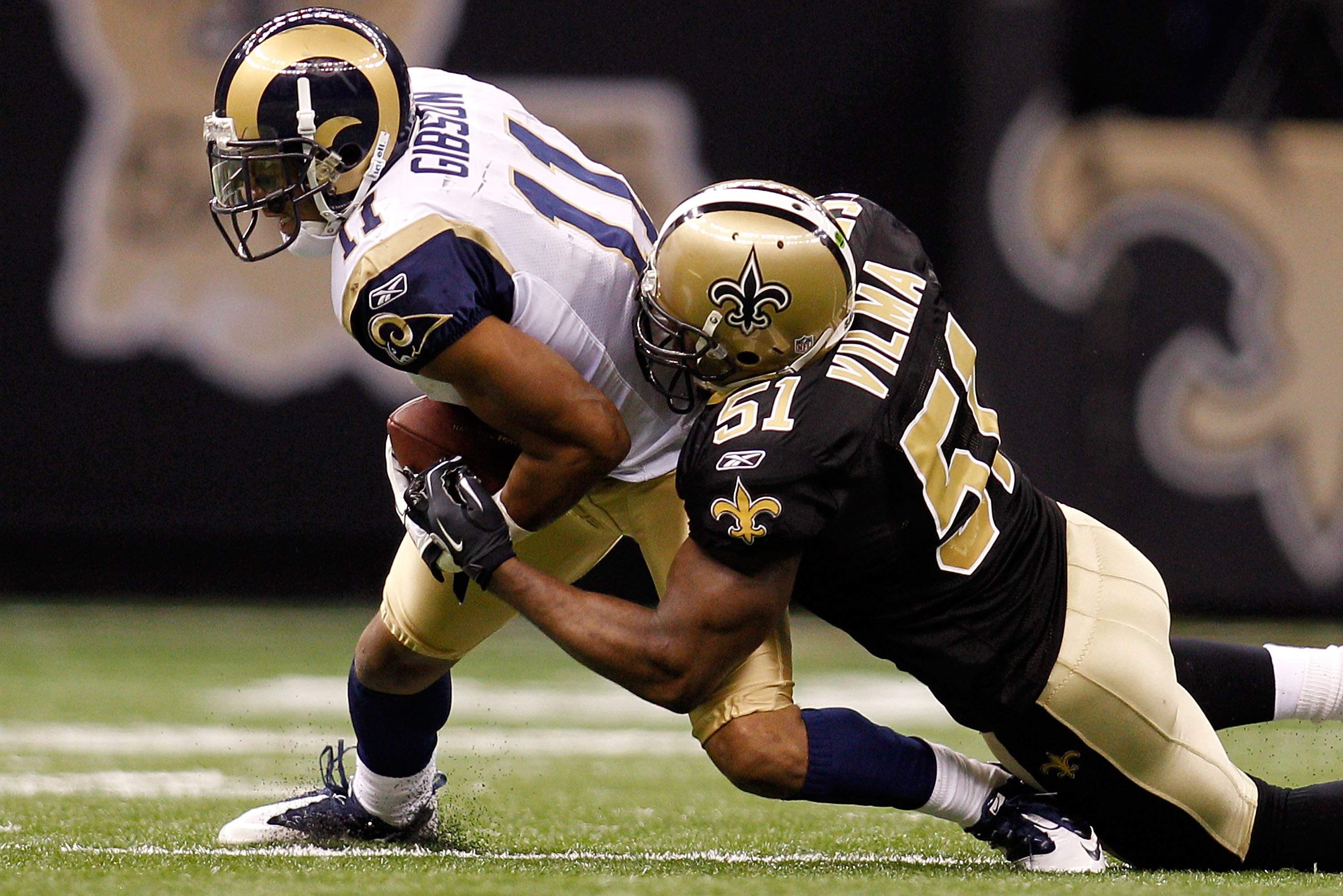 NEW ORLEANS, LA - DECEMBER 12:  Brandon Gibson #11 of the St. Louis Rams is tackled by Jonathan Vilma #51 of the New Orleans Saints at the Louisiana Superdome on December 12, 2010 in New Orleans, Louisiana. The Saints defeated the Rams 31-13.  (Photo by C