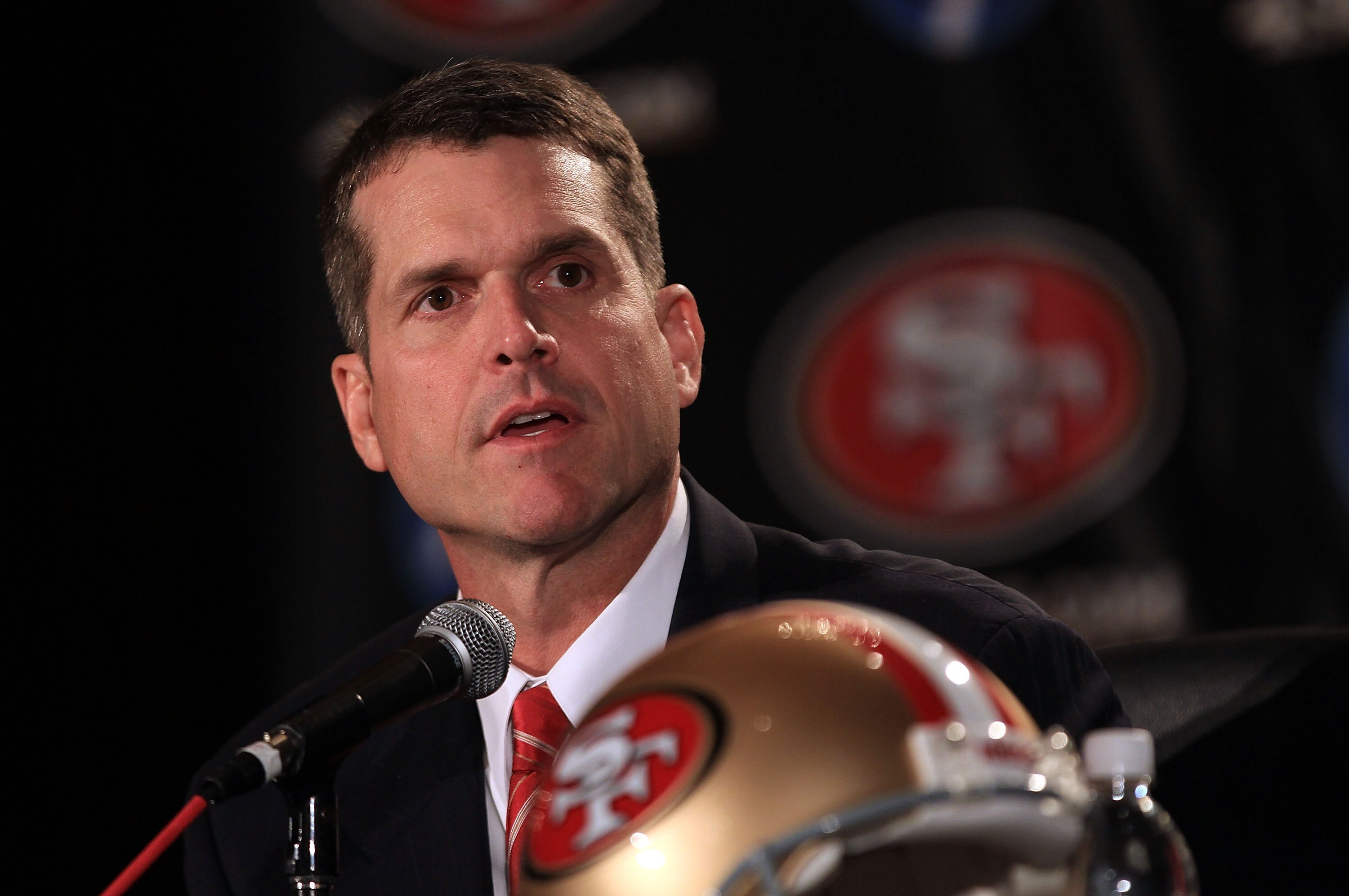 SAN FRANCISCO, CA - JANUARY 07:  Jim Harbaugh speaks at a press conference where he was introduced as the new San Francisco 49ers head coach at the Palace Hotel on January 7, 2011 in San Francisco, California.  (Photo by Ezra Shaw/Getty Images)