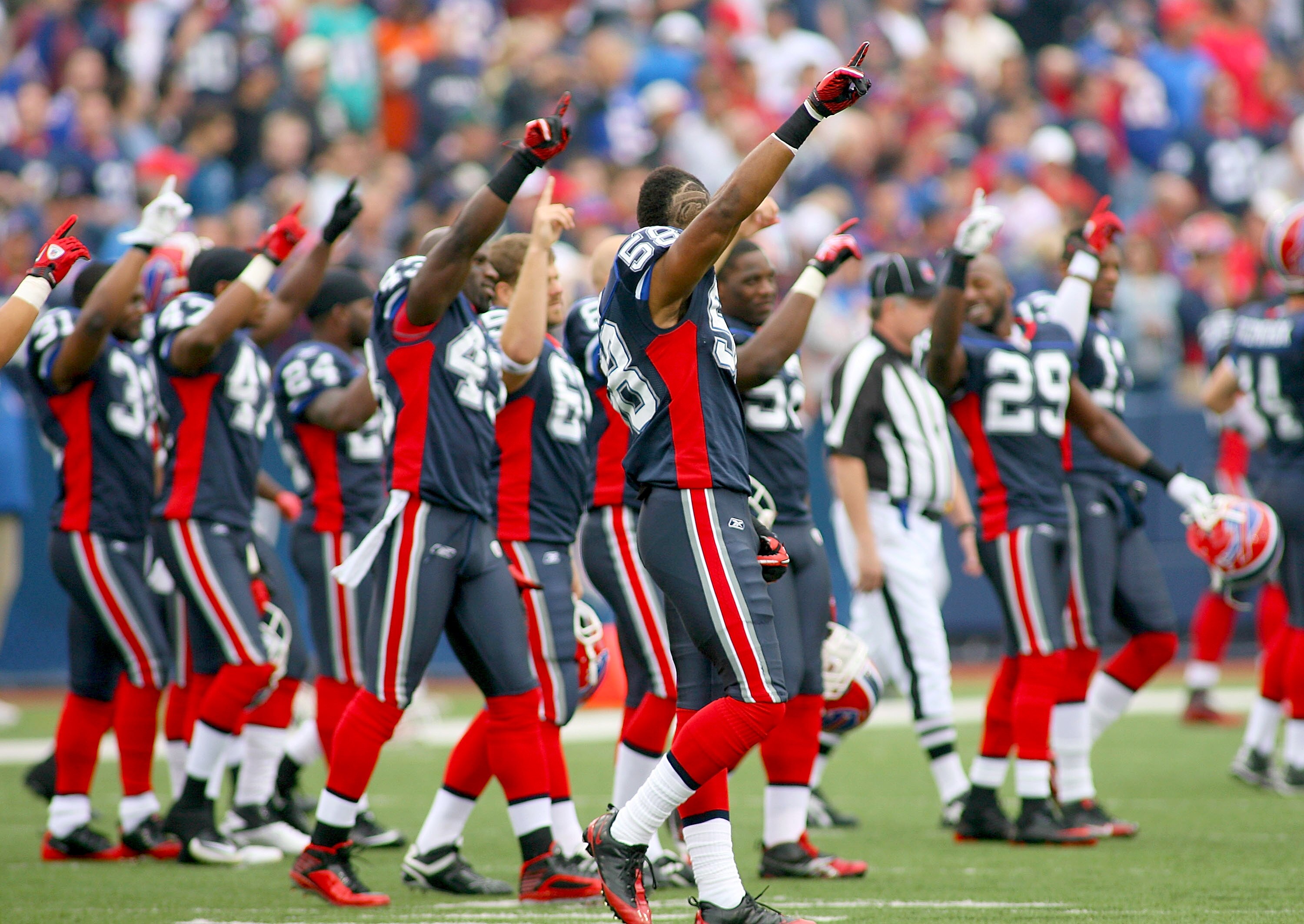 ORCHARD PARK, NY - SEPTEMBER 12: Players on the  Buffalo Bills raise their fingers to show solidarity amongst the NFL players for the upcoming labor talks prior to playing the Miami Dolphins in the NFL season opener at Ralph Wilson Stadium on September 12