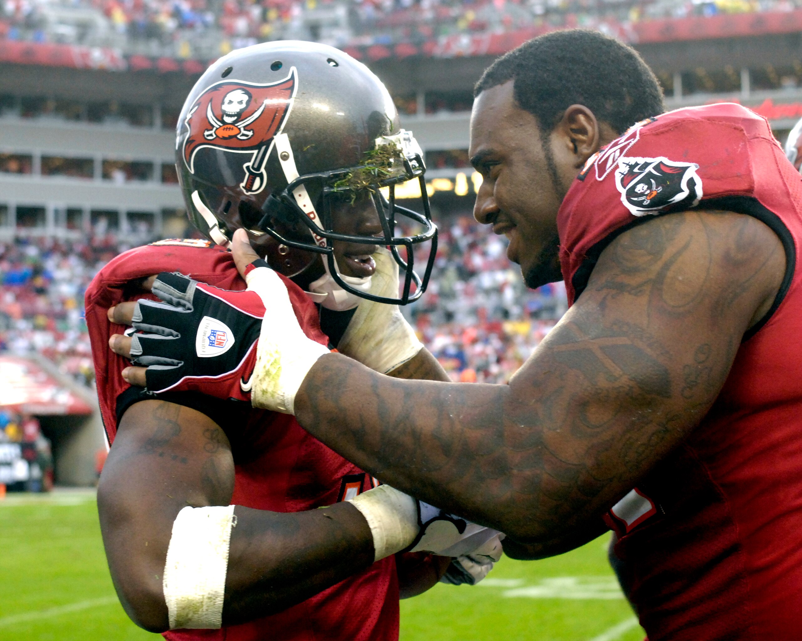 TAMPA, FL - NOVEMBER 30: Cornerback Philip Buchanan #31 of the Tampa Bay Buccaneers celebrates a second-half interception with defensive tackle Jovan Haye #71 against the New Orleans Saints at Raymond James Stadium on November 30, 2008 in Tampa, Florida.