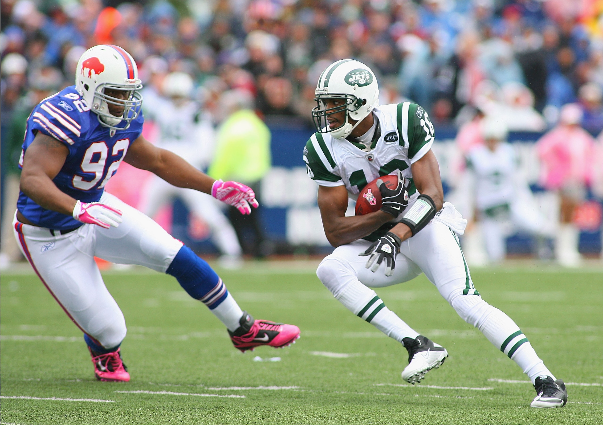 ORCHARD PARK, NY - OCTOBER 03:  Brad Smith #16 of the New York Jets runs around  Alex Carrington #92 of the Buffalo Bills at Ralph Wilson Stadium on October 3, 2010 in Orchard Park, New York. The Jets won 38-14.  (Photo by Rick Stewart/Getty Images)