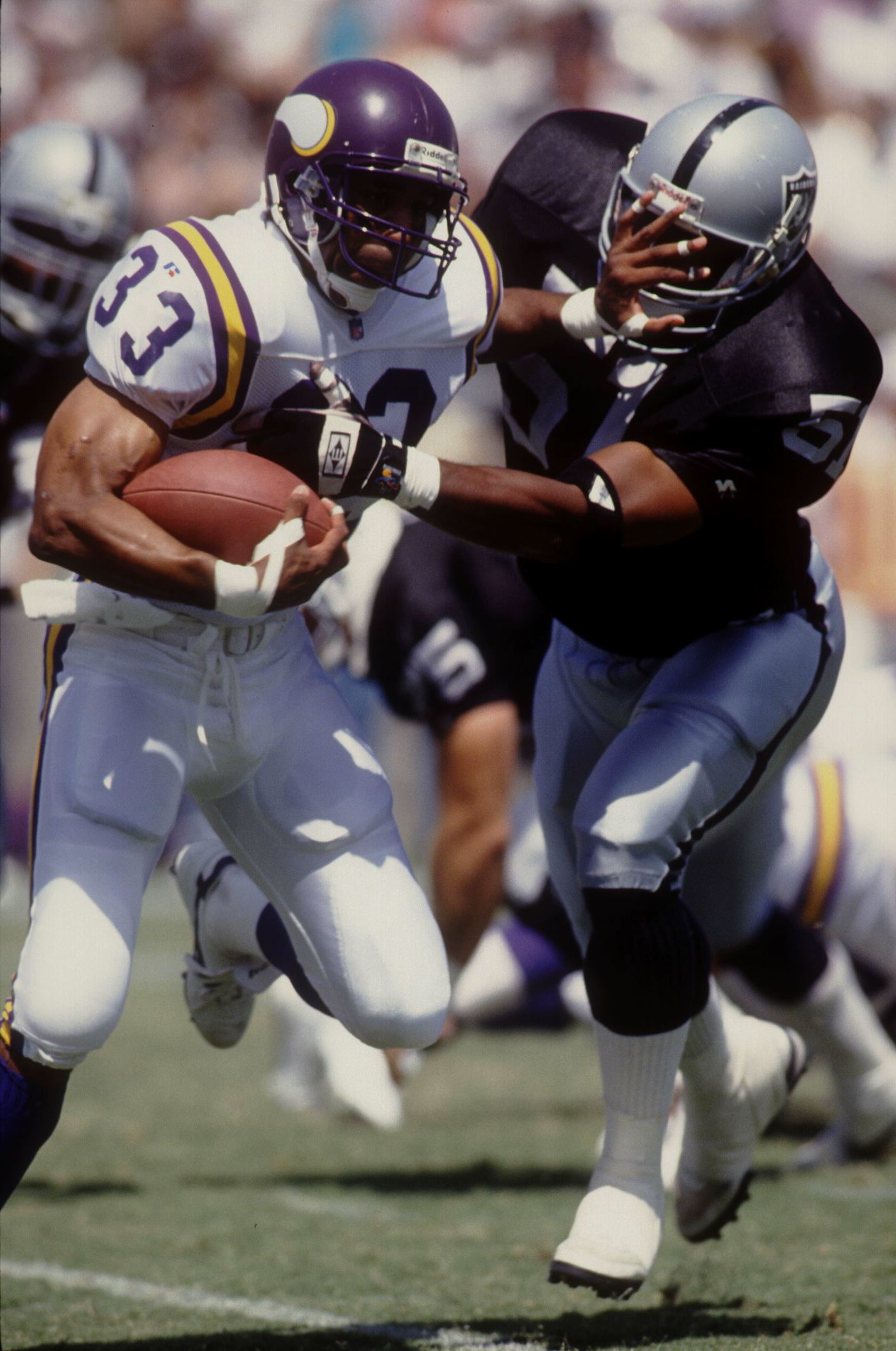 5 Sep 1993: Vikings RB Roger Craig stiff-arms the Raider's Aaron Wallace during first quarter action.