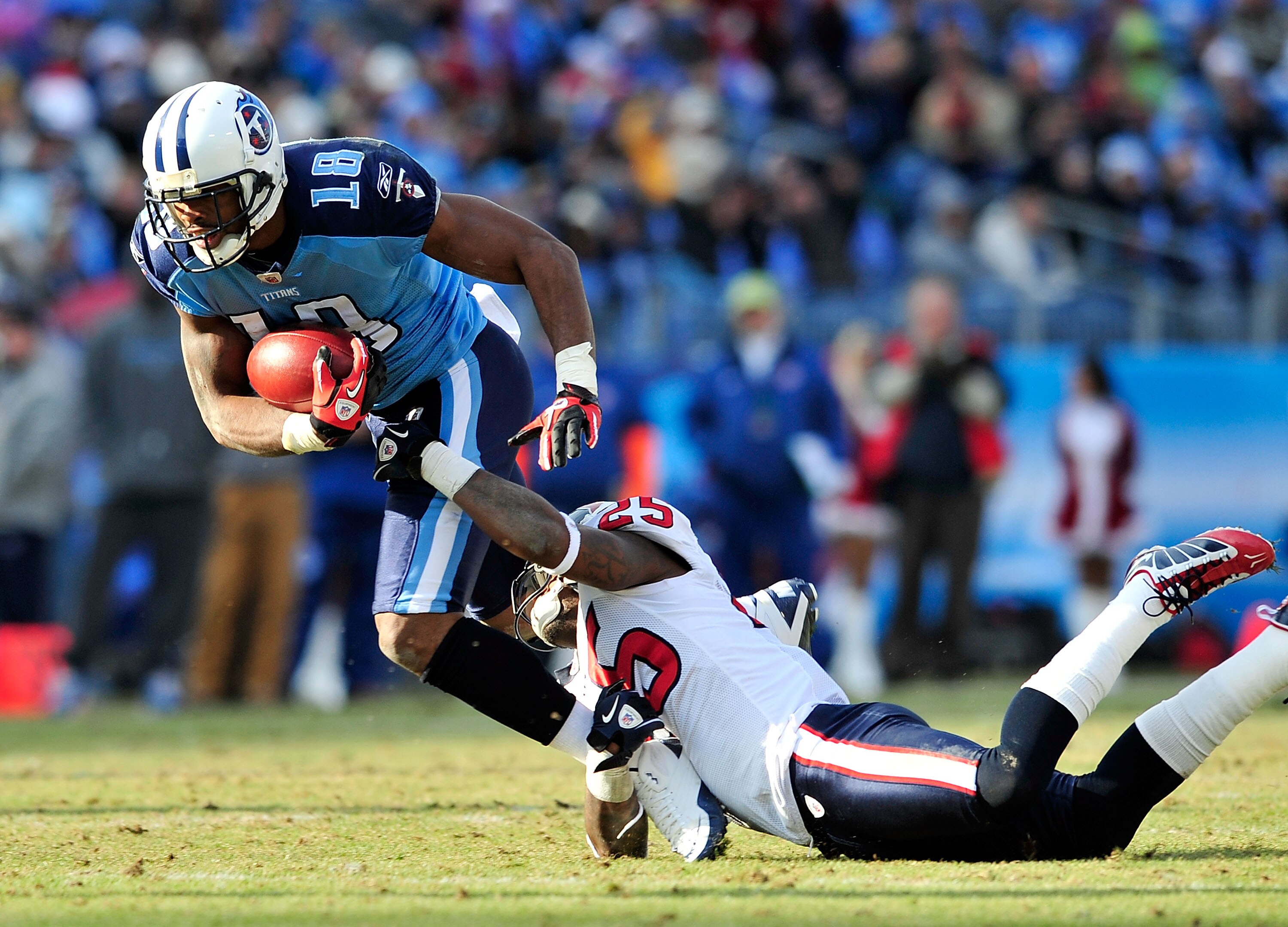 NASHVILLE, TN - DECEMBER 19:  Kenny Britt #18 of the Tennessee Titans breaks away from Kareem Jackson #25 of the Houston Texans at LP Field on December 19, 2010 in Nashville, Tennessee. The Titans defeated the Texans, 31-17.  (Photo by Grant Halverson/Get