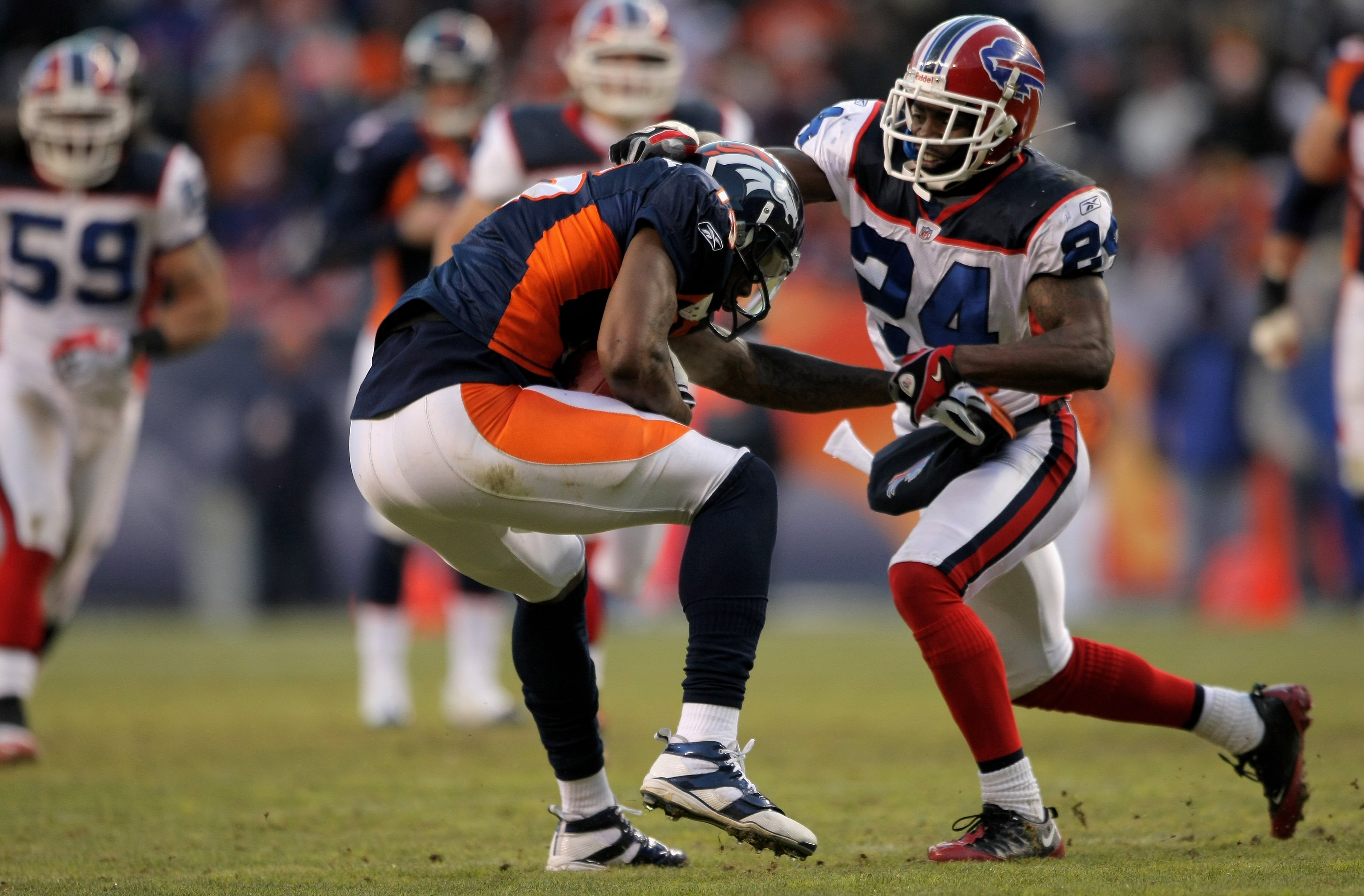 DENVER - DECEMBER 21:  Wide receiver Brandon Marshall #15 of the Denver Broncos makes a reception as Terrence McGee #24 of the Buffalo Bills defends during NFL action at Invesco Field at Mile High on December 21, 2008 in Denver, Colorado. The Bills defeat