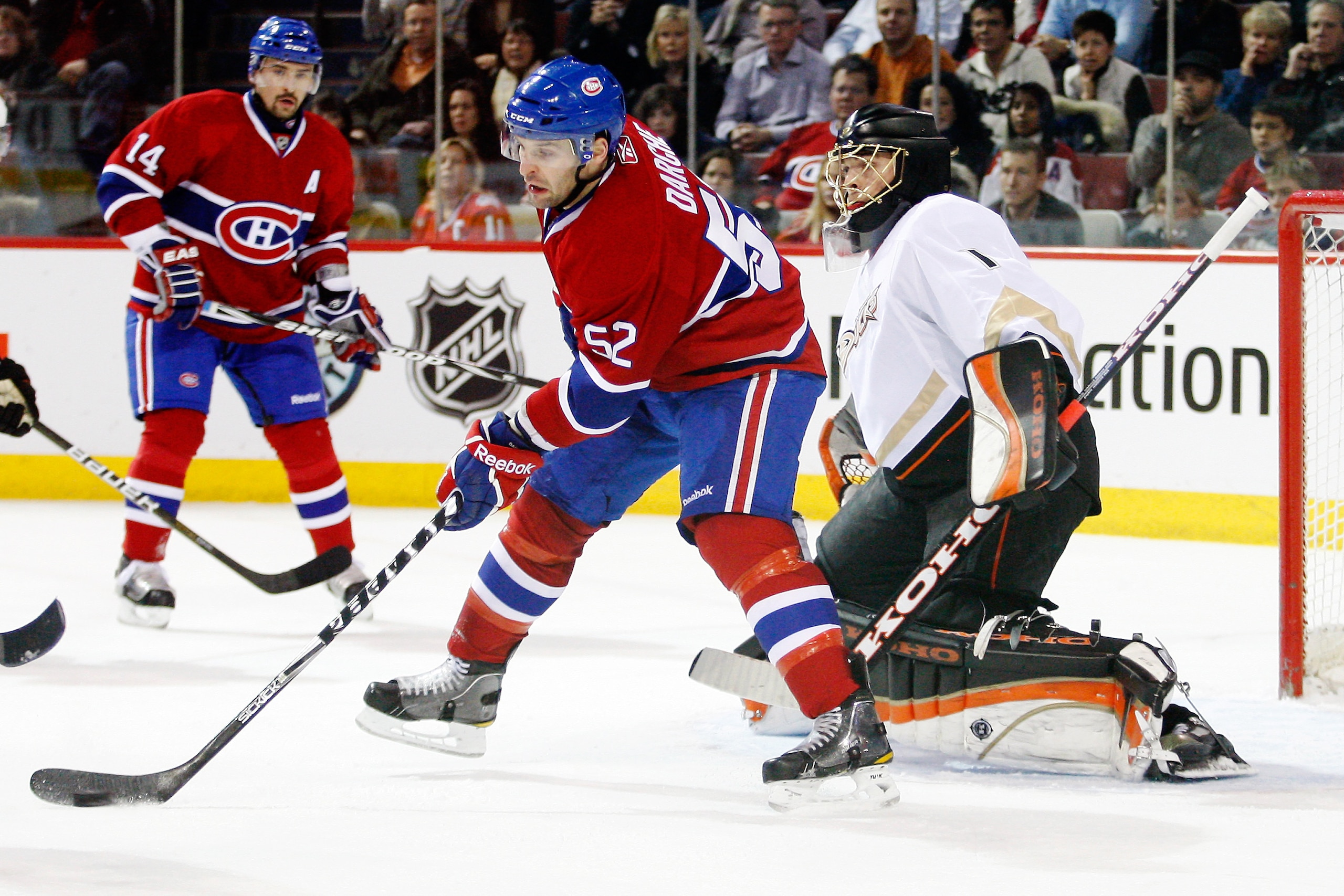 MONTREAL, CANADA - JANUARY 22: Mathieu Darche #52 of the Montreal Canadiens attempts to deflect the puck in front of Jonas Hiller #1 of the Anaheim Ducks during the NHL game at the Bell Centre on January 22, 2011 in Montreal, Quebec, Canada. (Photo by R MONTREAL, CANADA - JANUARY 22: Mathieu Darche #52 of the Montreal Canadiens attempts to deflect the puck in front of Jonas Hiller #1 of the Anaheim Ducks during the NHL game at the Bell Centre on January 22, 2011 in Montreal, Quebec, Canada. (Photo by R