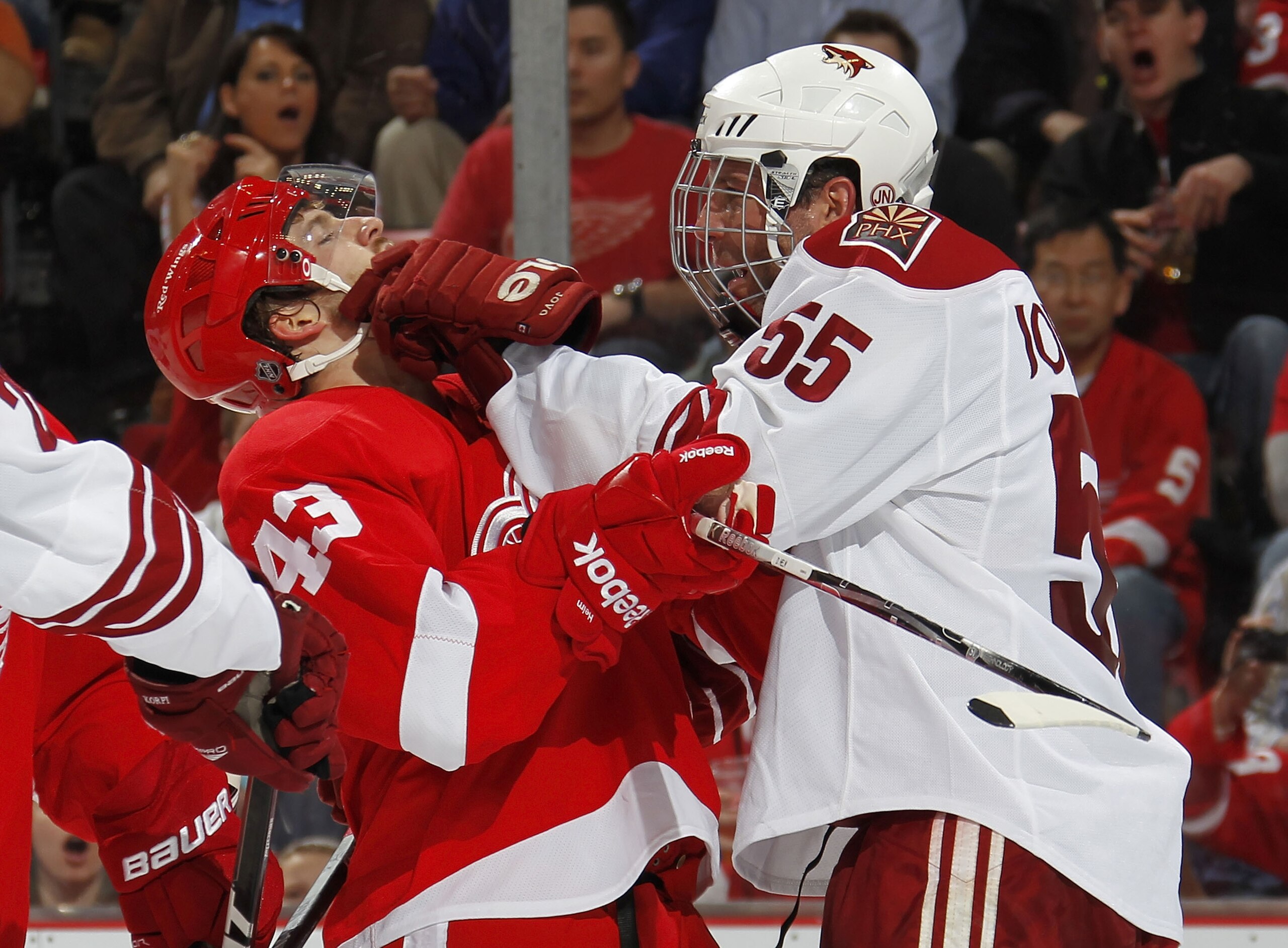 DETROIT, MI - APRIL 16:  Ed Jovanovski #55 of the Phoenix Coyotes puts a glove in the face of Darren Helm #43 of the Detroit Red Wings in Game Two of the Western Conference Quarterfinals during the 2011 Stanley Cup Playoffs at Joe Louis Arena on April 16,