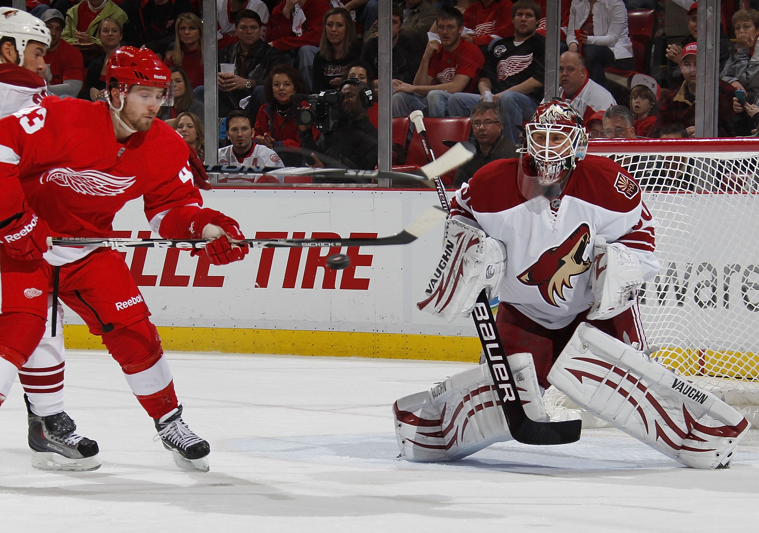 DETROIT, MI - APRIL 16: Ilya Bryzgalov #30 of the Phoenix Coyotes keeps an eye on the puck as it passes the stick of Darren Helm #43 of the Detroit Red Wings in Game Two of the Western Conference Quarterfinals during the 2011 Stanley Cup Playoffs at Joe DETROIT, MI - APRIL 16: Ilya Bryzgalov #30 of the Phoenix Coyotes keeps an eye on the puck as it passes the stick of Darren Helm #43 of the Detroit Red Wings in Game Two of the Western Conference Quarterfinals during the 2011 Stanley Cup Playoffs at Joe