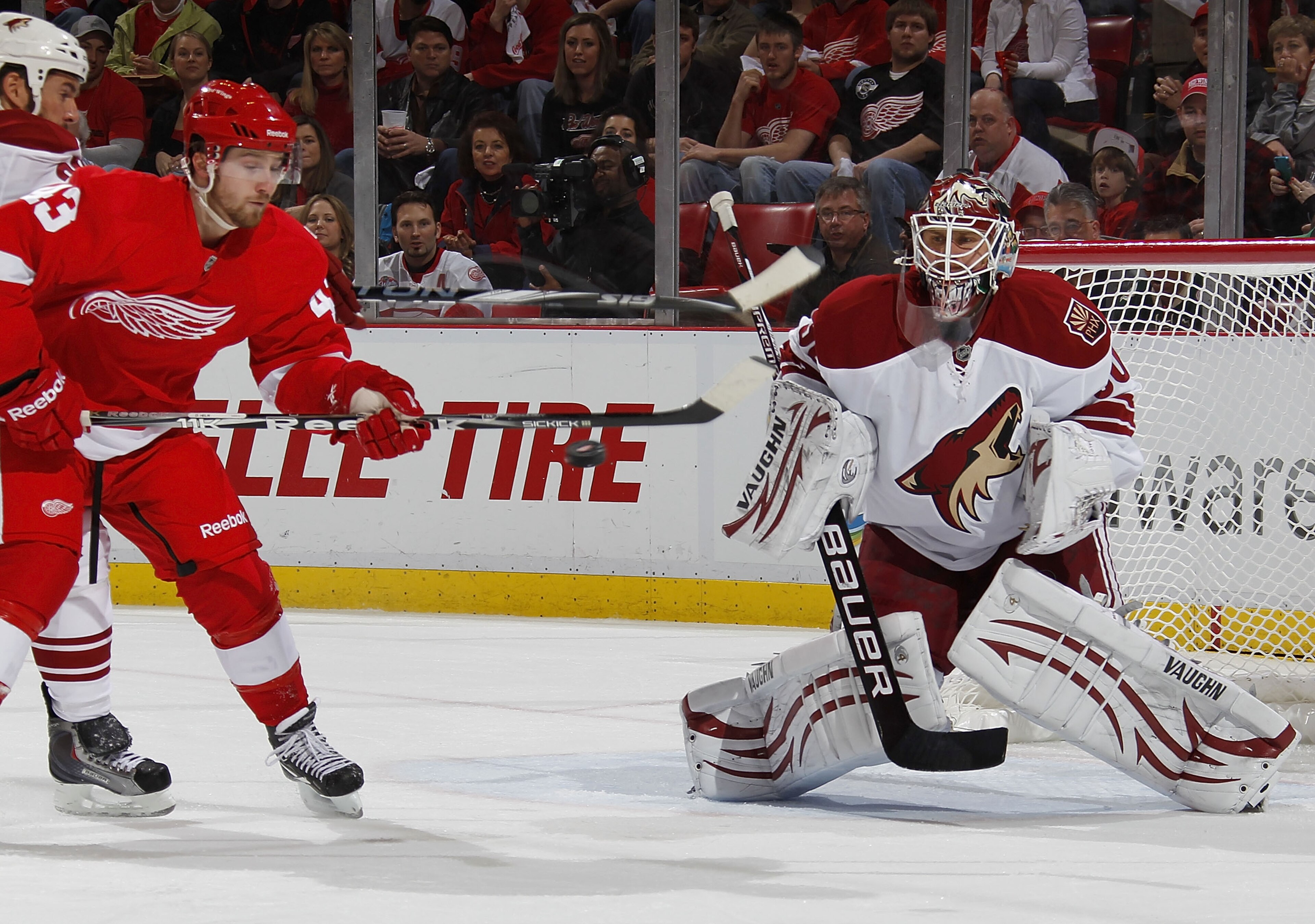 DETROIT, MI - APRIL 16:  Ilya Bryzgalov #30 of the Phoenix Coyotes keeps an eye on the puck as it passes the stick of Darren Helm #43 of the Detroit Red Wings in Game Two of the Western Conference Quarterfinals during the 2011 Stanley Cup Playoffs at Joe