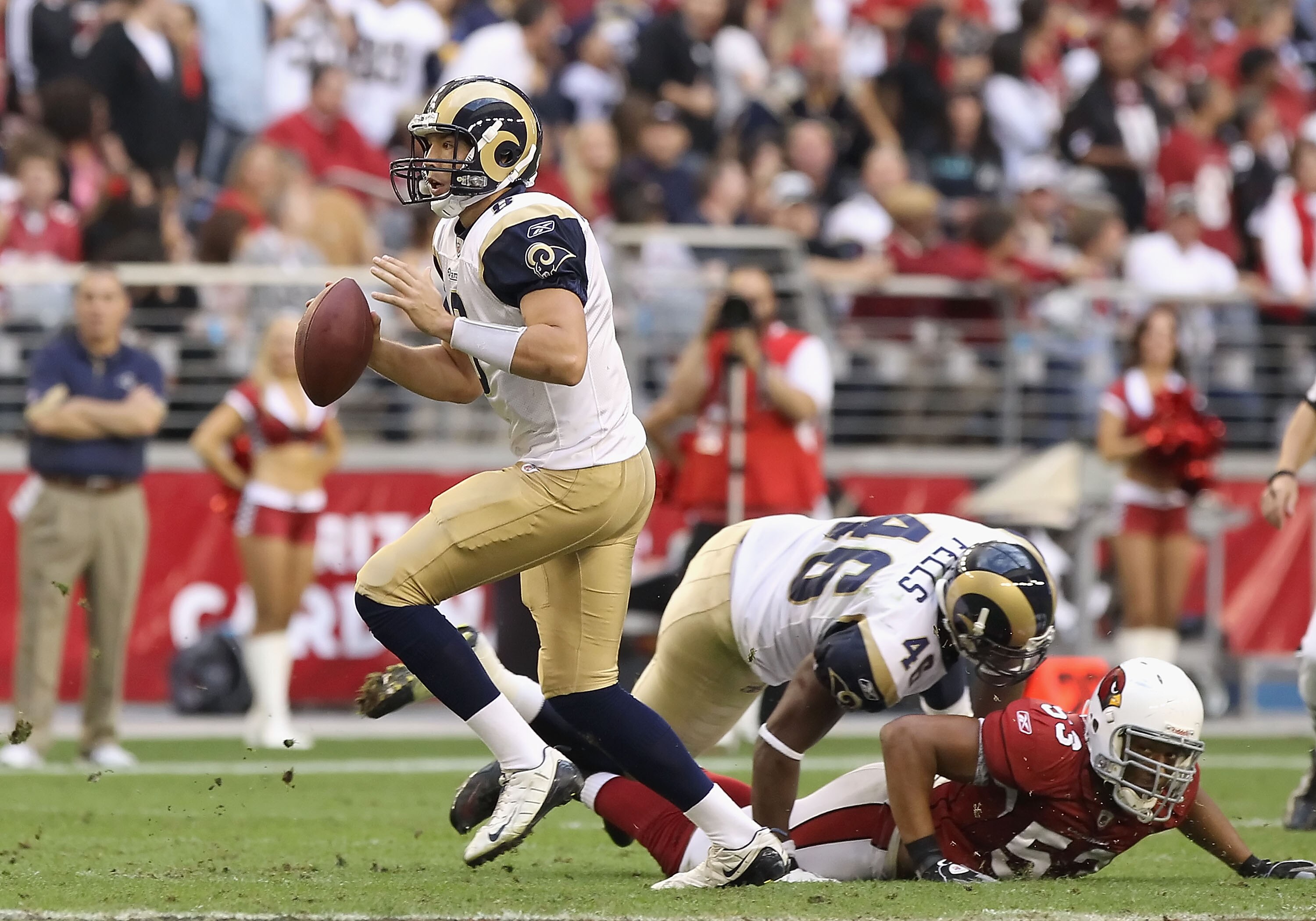 GLENDALE, AZ - DECEMBER 05:  Quarterback Sam Bradford #8 of the St. Louis Rams scrambles with the football during the NFL game against the Arizona Cardinals at the University of Phoenix Stadium on December 5, 2010 in Glendale, Arizona. The Rams defeated t