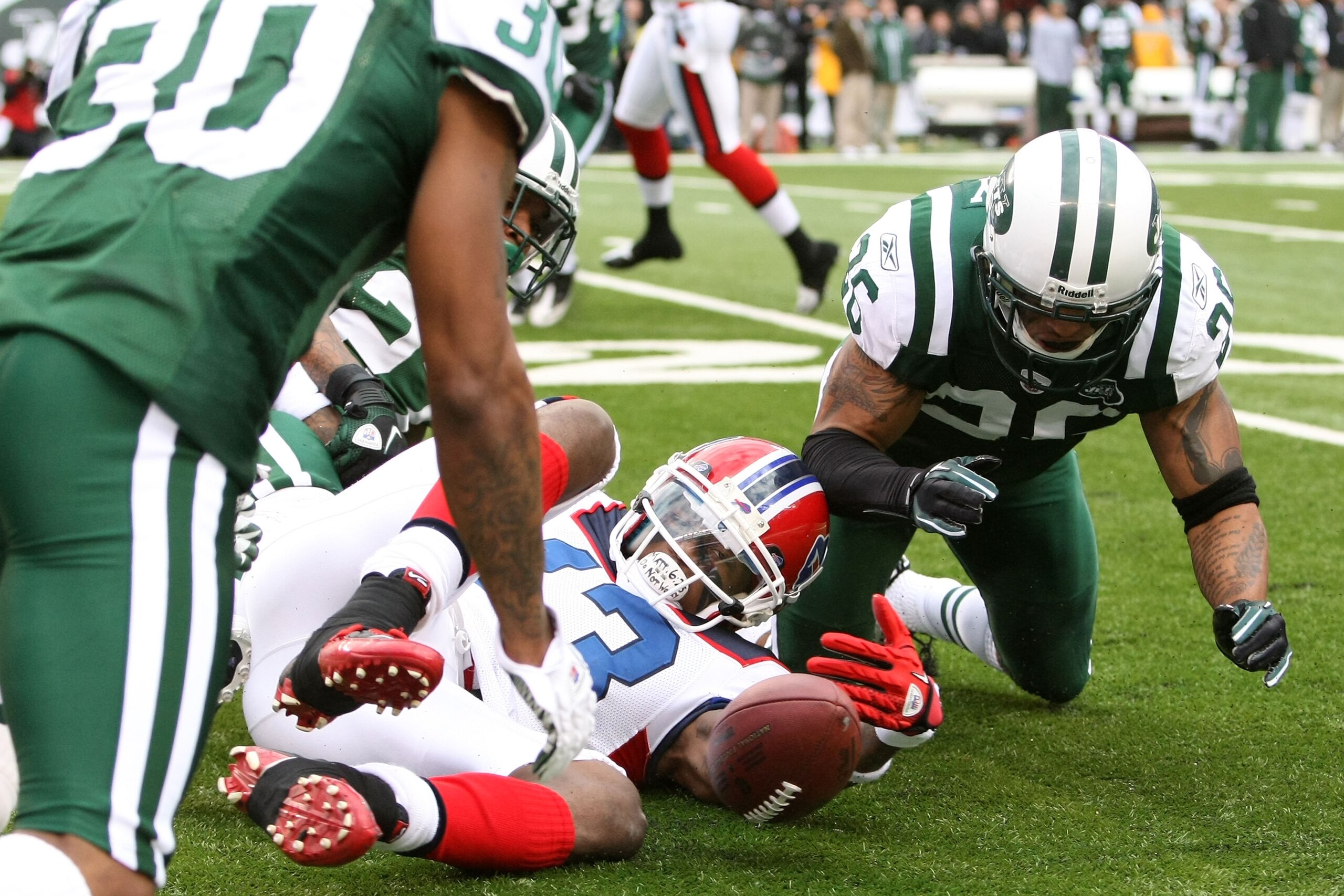 EAST RUTHERFORD, NJ - JANUARY 02:  Steve Johnson #13 of the Buffalo Bills fumbles against Dwight Lowery #26 of the New York Jets at New Meadowlands Stadium on January 2, 2011 in East Rutherford, New Jersey.  (Photo by Michael Heiman/Getty Images)