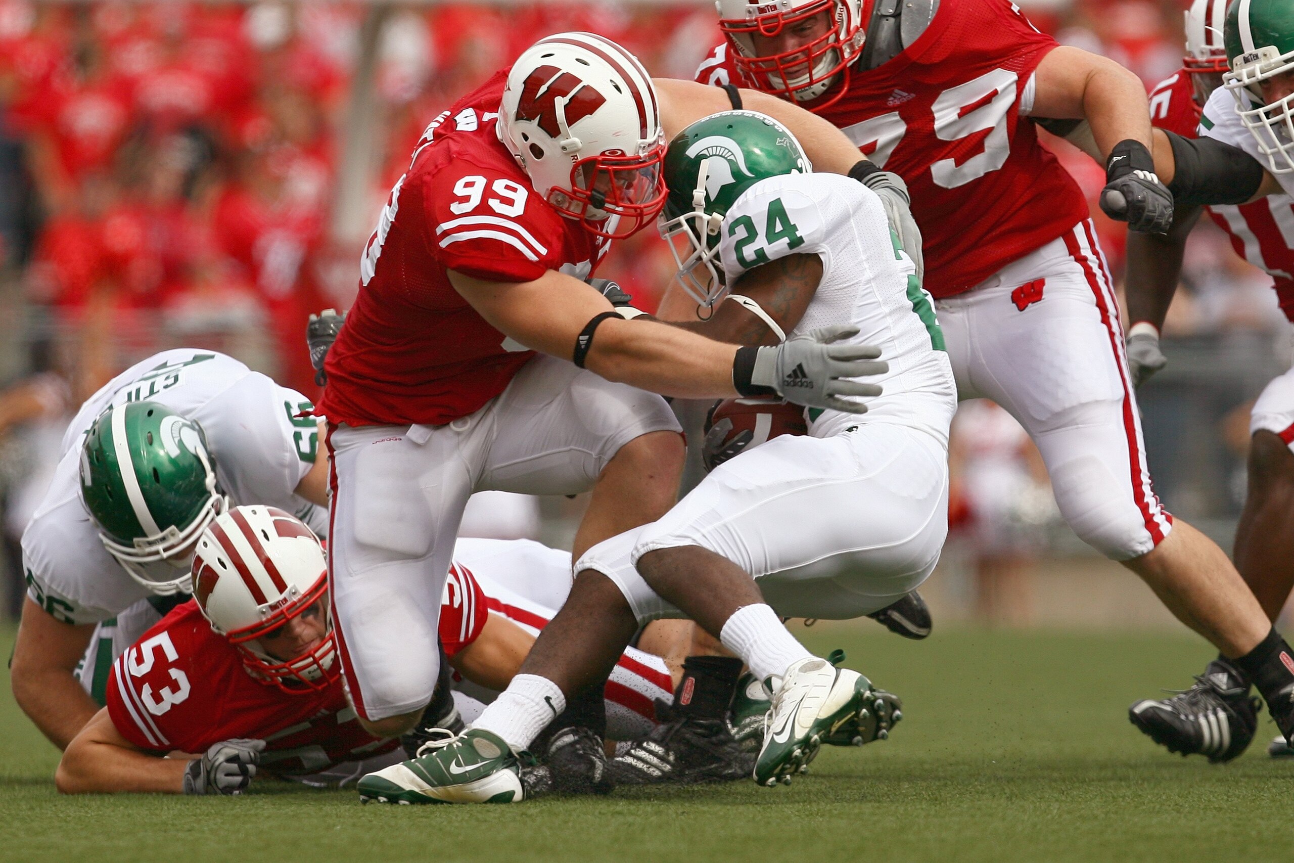MADISON, WI - SEPTEMBER 26: J.J. Watt #99 of the Wisconsin Badgers tackles Caulton Ray #24 of the Michigan State Spartans on September 26, 2009 at Camp Randall Stadium in Madison, Wisconsin. Wisconsin defeated Michigan State 38-30. (Photo by Jonathan Dani