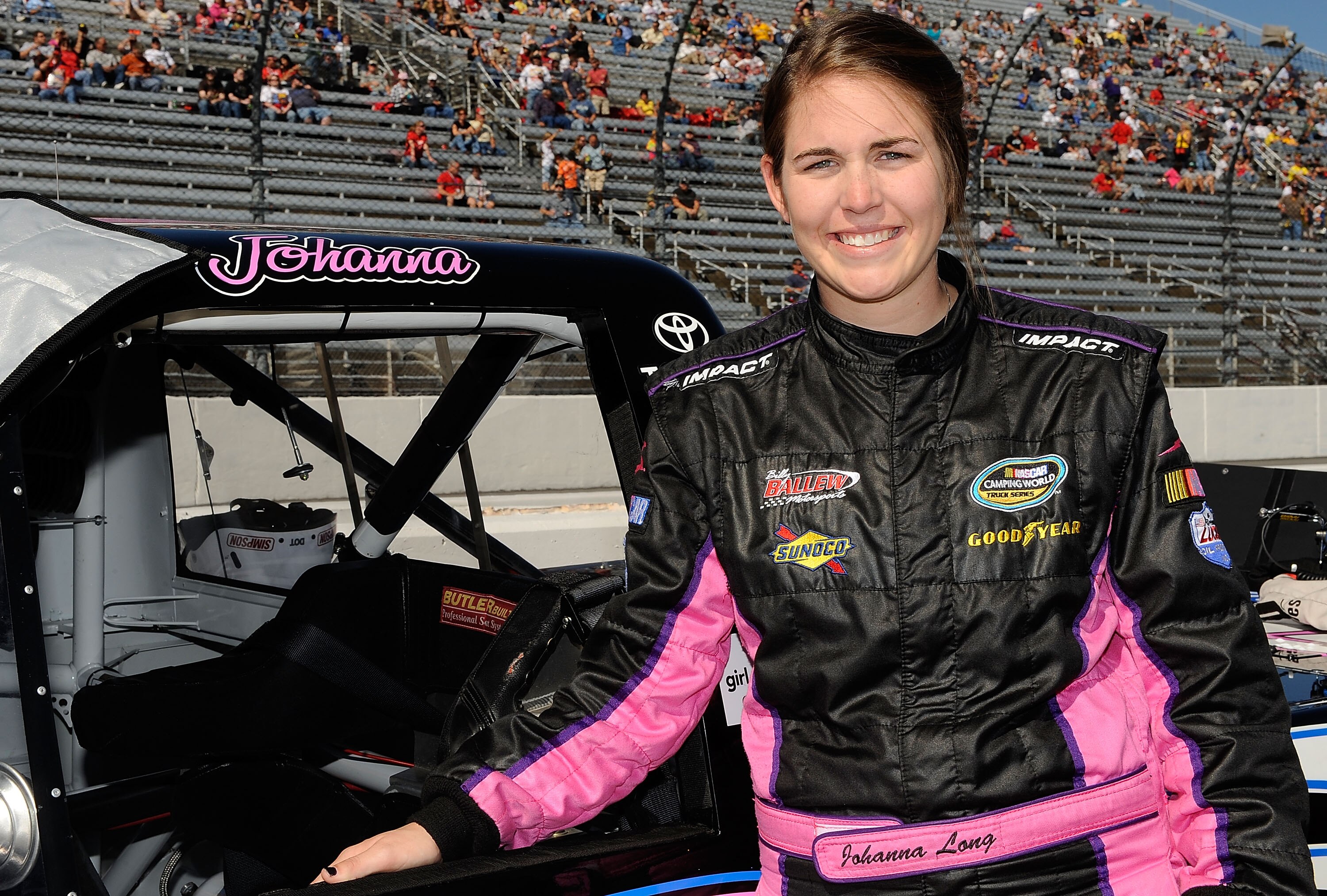 MARTINSVILLE, VA - OCTOBER 23:  Johanna Long, driver of the #20 Panhandle Grading & Paving Toyota, stands by her truck on the grid prior to the start of the NASCAR Camping World Truck Series Kroger 200 at Martinsville Speedway on October 23, 2010 in Marti
