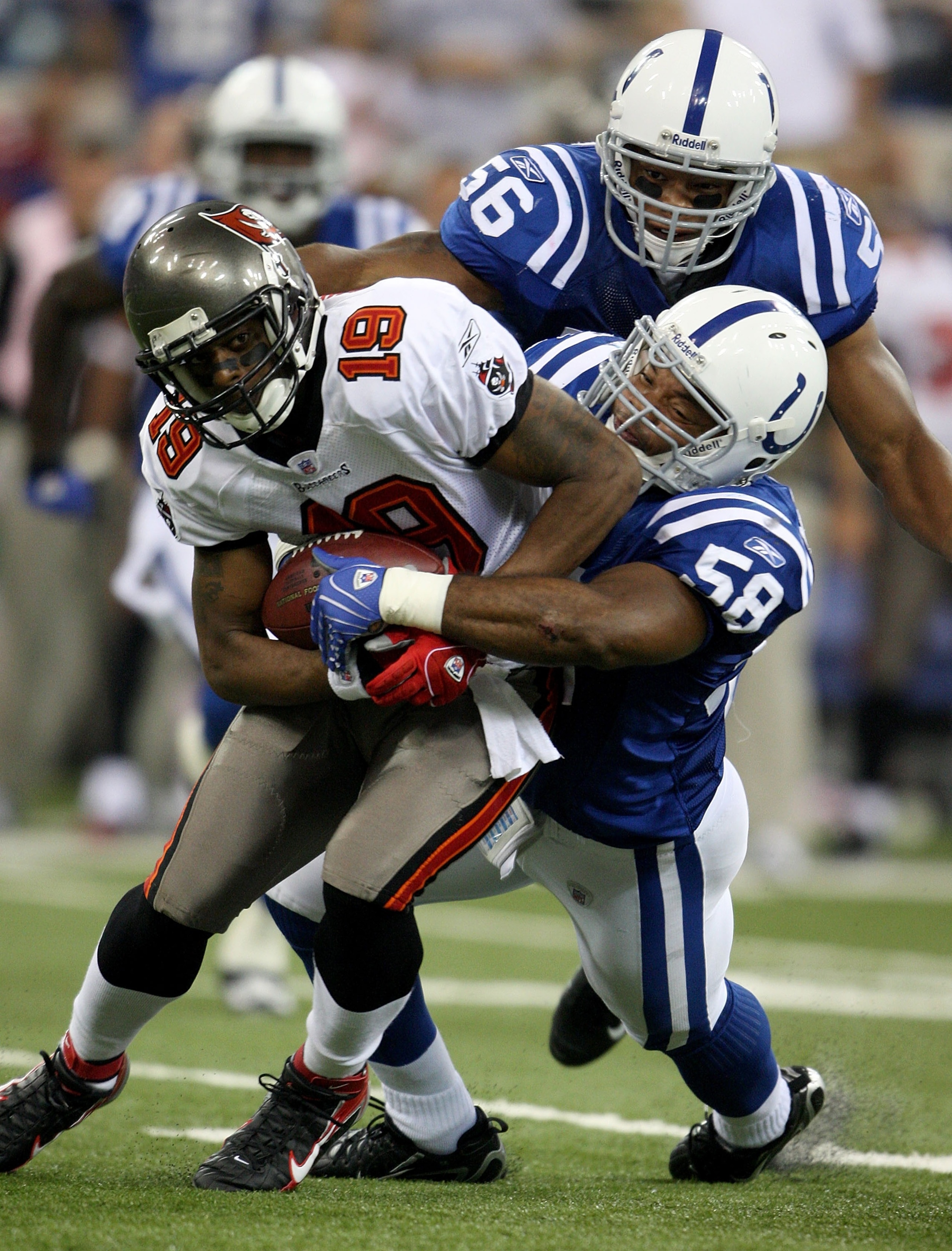 INDIANAPOLIS - OCTOBER 7:  Gary Brackett #58 of the Indianapolis Colts tackles Ike Hilliard #19 of the Tampa Bay Buccaneers during the NFL game October 7, 2007 at the RCA Dome in Indianapolis, Indiana.  (Photo by Andy Lyons/Getty Images)