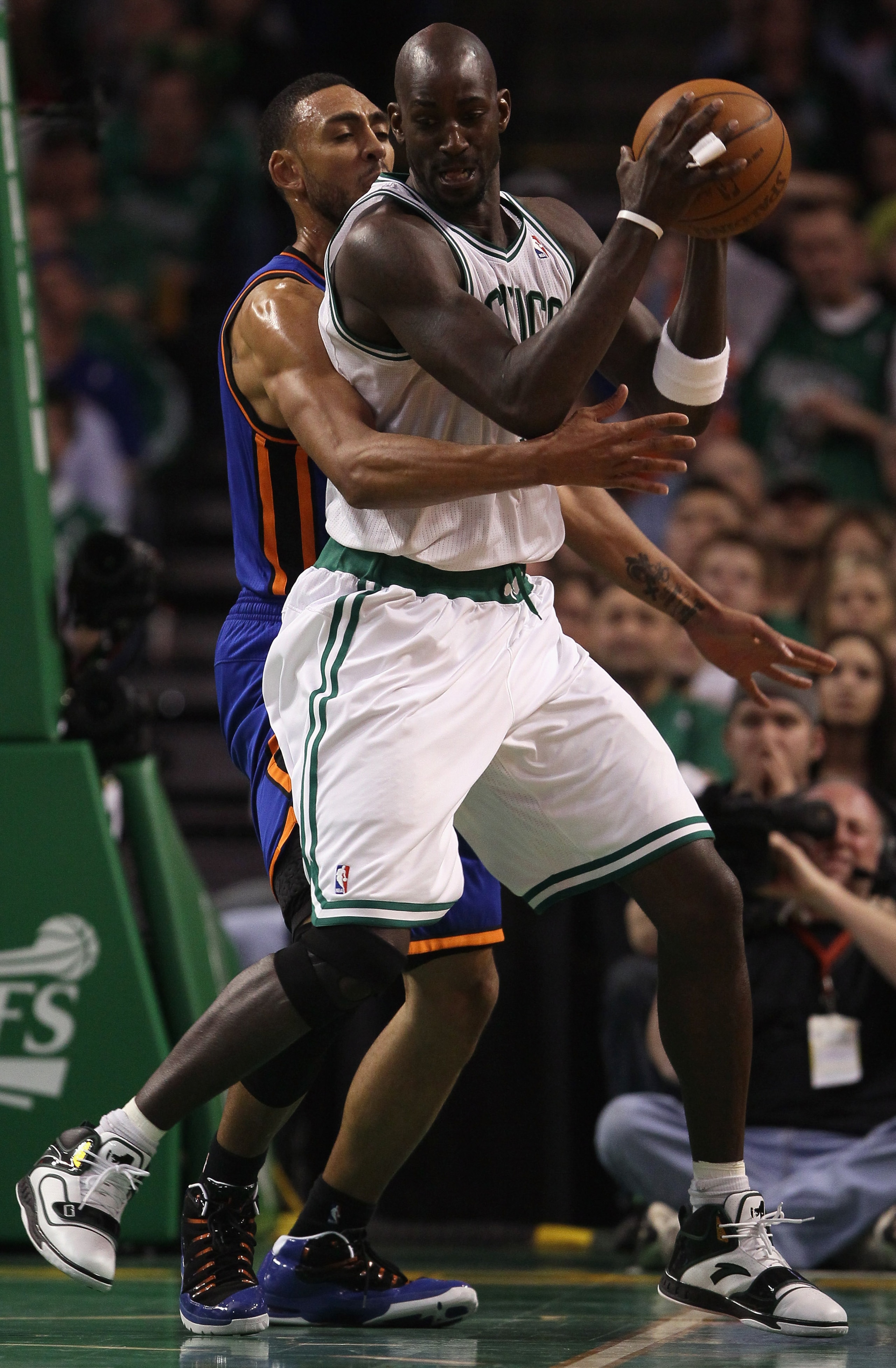 BOSTON, MA - APRIL 19:  Kevin Garnett #5 of the Boston Celtics heads for the net as Jared Jeffries #9 of the New York Knicks defends in Game Two of the Eastern Conference Quarterfinals in the 2011 NBA Playoffs on April 19, 2011 at the TD Garden in Boston,
