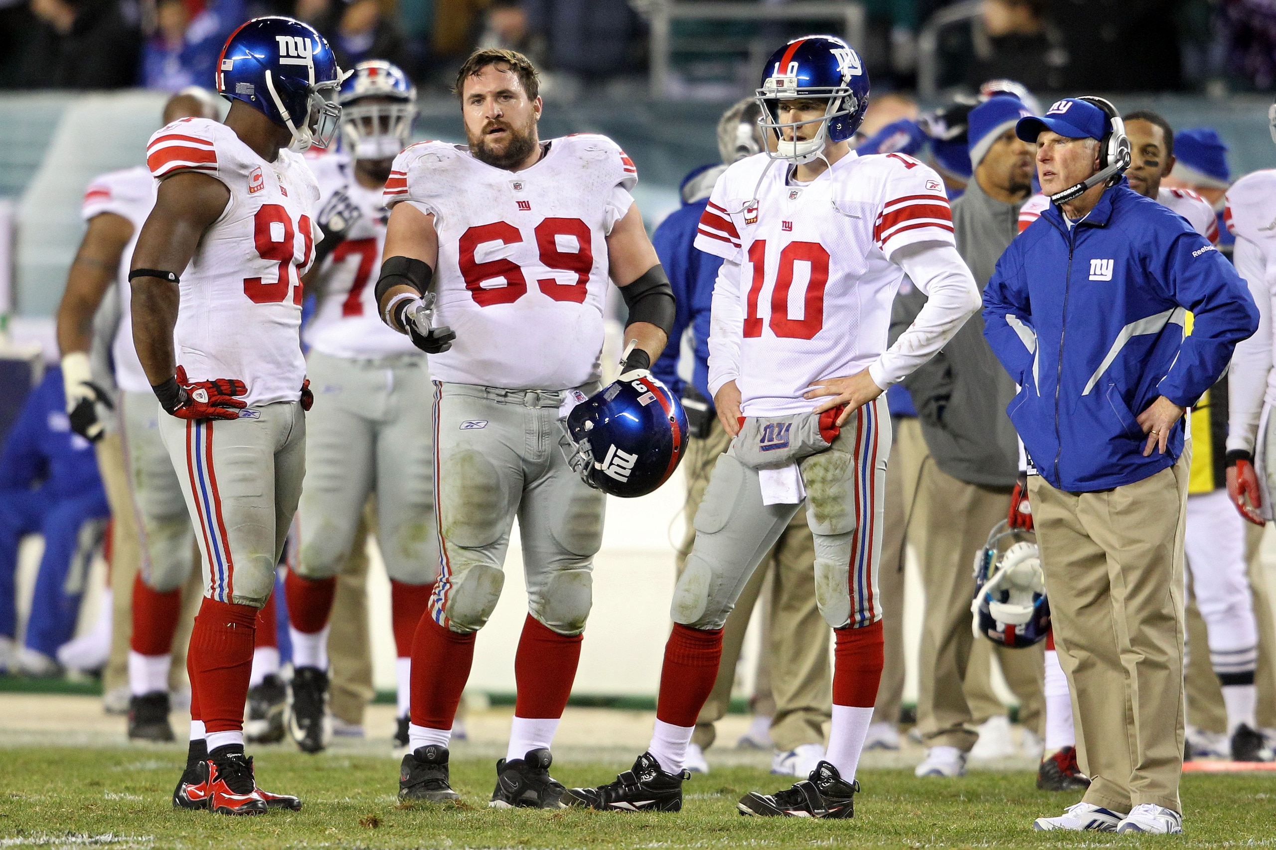 PHILADELPHIA - NOVEMBER 21:  Justin Tuck #91, Rich Seubert #69, Eli Manning #10 and head coach Tom Coughlin of the New York Giants look on during a challenge on a fumble by Manning late in the fourth quarter against the Philadelphia Eagles at Lincoln Fina