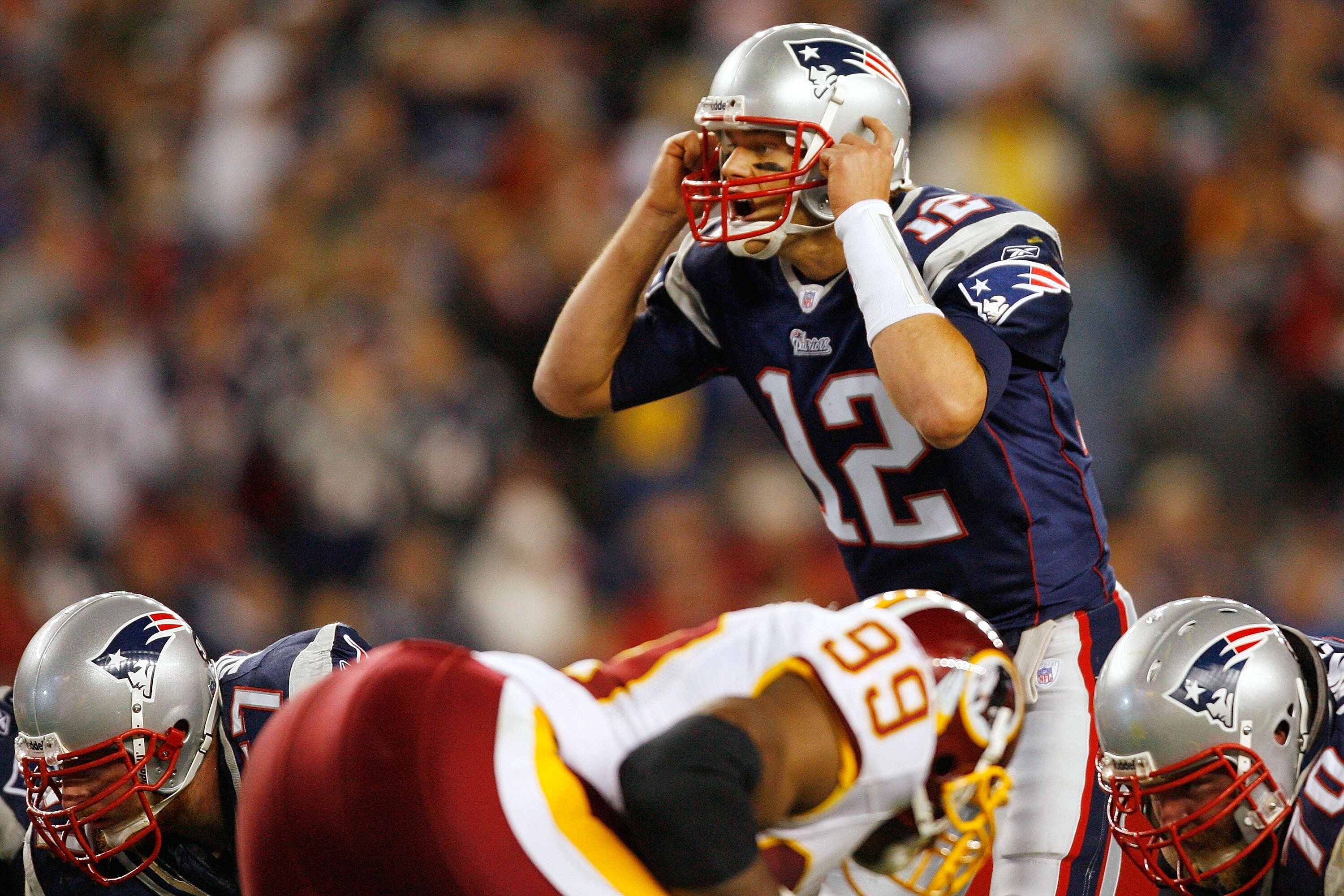 FOXBORO, MA - OCTOBER 28:  Quarterback Tom Brady #12 of the New England Patriots calls out the play in the second half against the Washington Redskins on October 28, 2007 at Gillette Stadium in Foxboro, Massachusetts. The Patriots defeated the Redskins 52