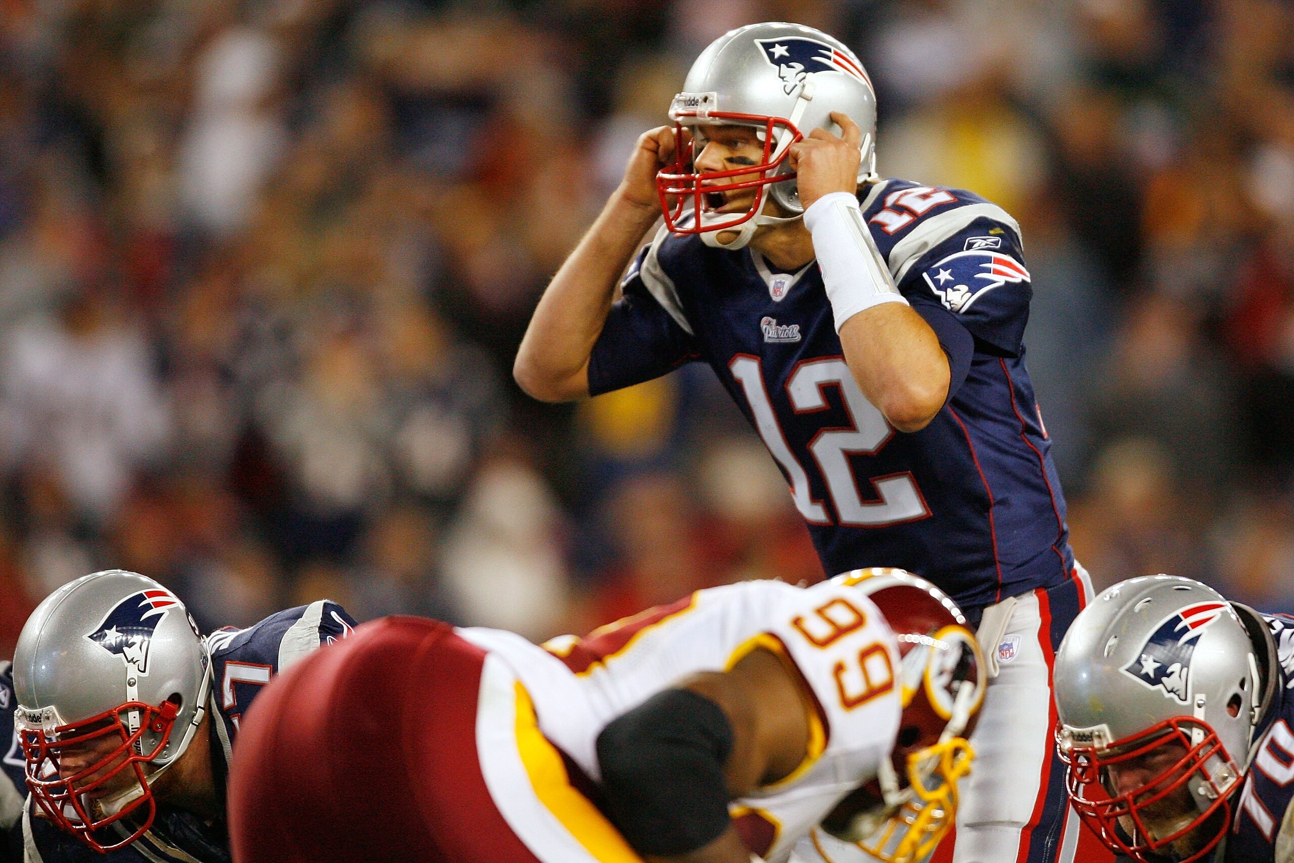 FOXBORO, MA - OCTOBER 28:  Quarterback Tom Brady #12 of the New England Patriots calls out the play in the second half against the Washington Redskins on October 28, 2007 at Gillette Stadium in Foxboro, Massachusetts. The Patriots defeated the Redskins 52