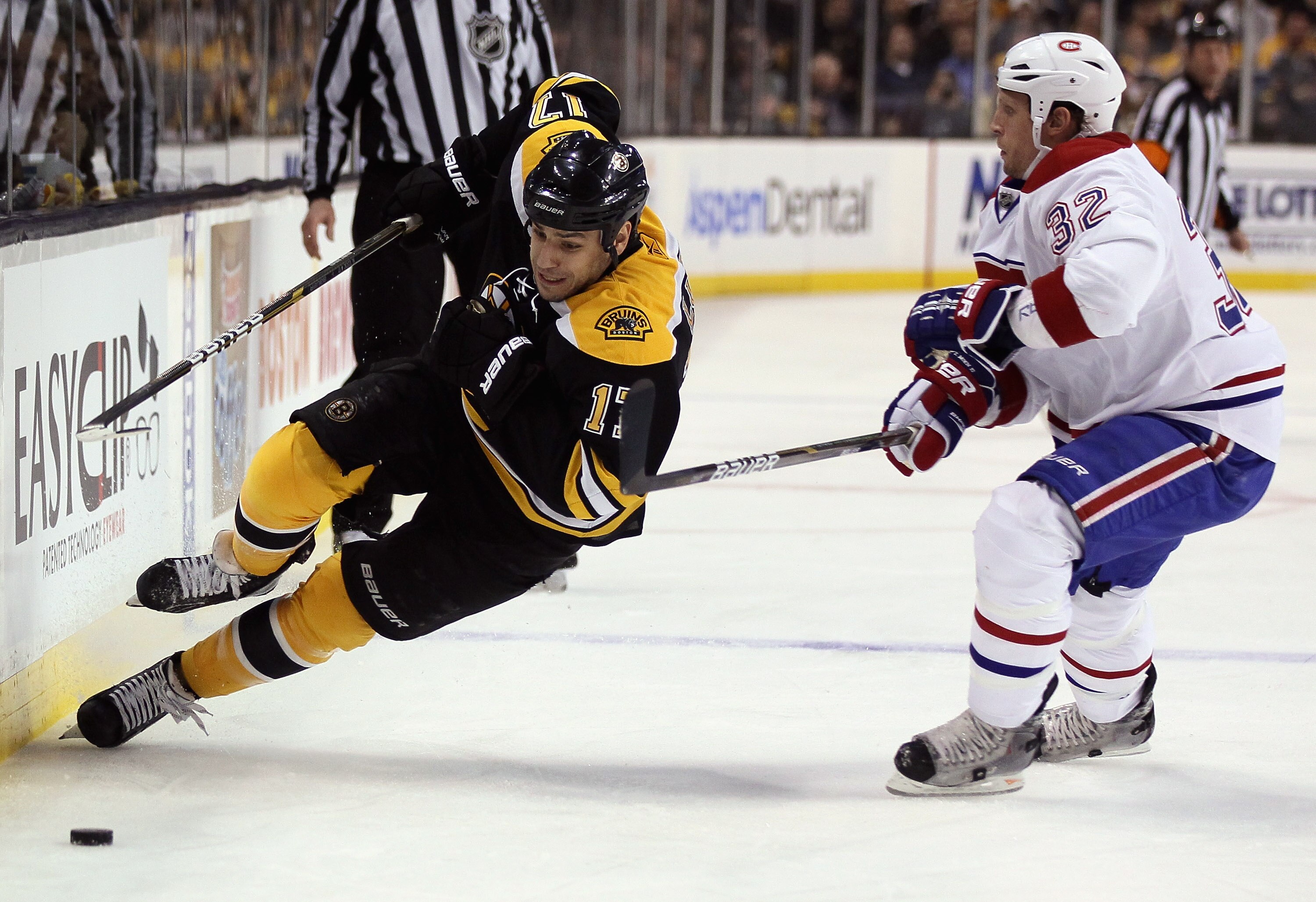 BOSTON, MA - APRIL 14:  Milan Lucic #17 of the Boston Bruins is hit by Travis Moen #32 of the Montreal Canadiens in Game One of the Eastern Conference Quarterfinals during the 2011 NHL Stanley Cup Playoffs at TD Garden on April 14, 2011 in Boston, Massach