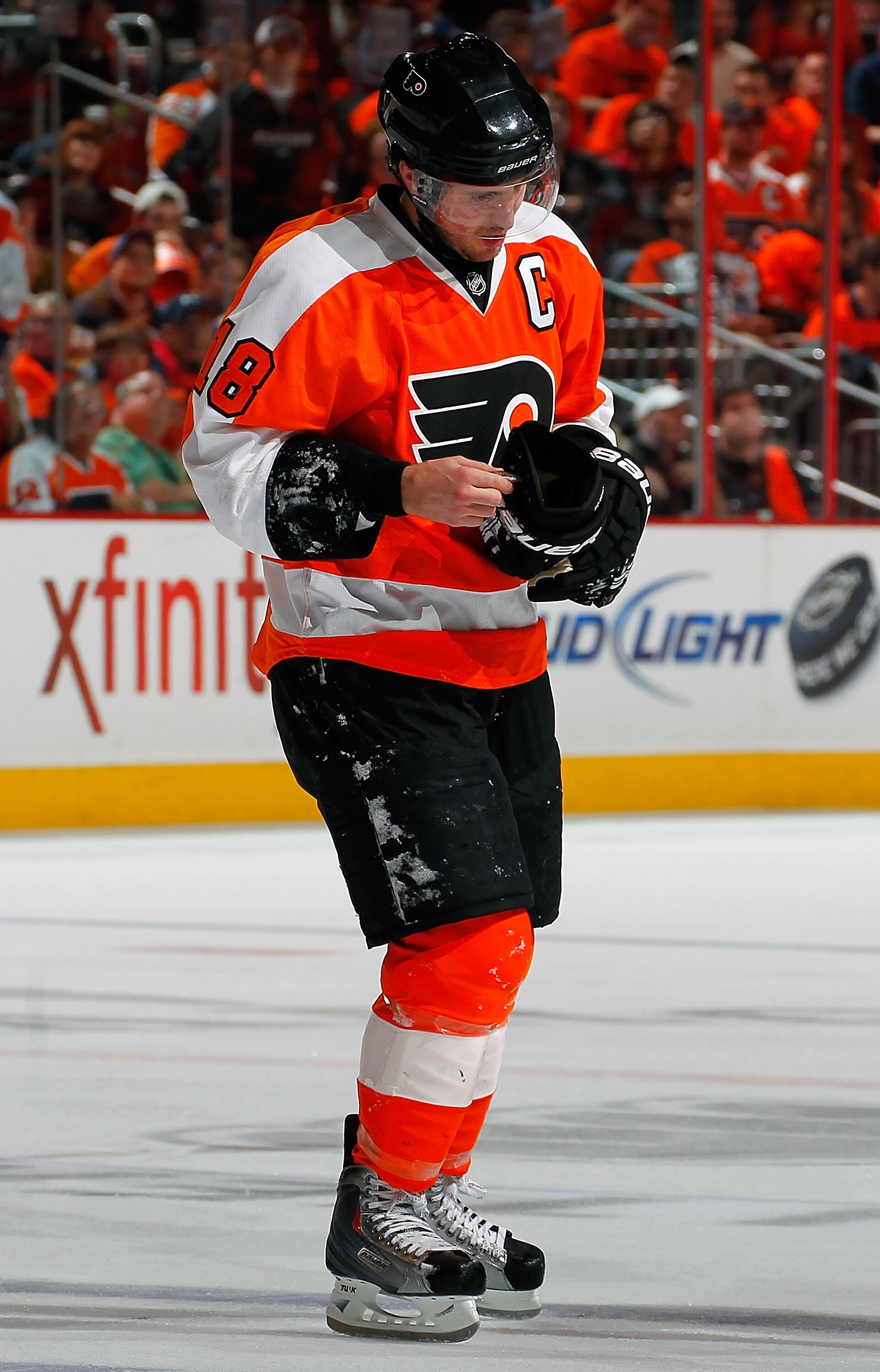PHILADELPHIA, PA - APRIL 16:  Mike Richards #18 of the Philadelphia Flyers skates slowly off the ice checking his hand after going down hard in Game Two of the Eastern Conference Quarterfinals against the Buffalo Sabres during the 2011 NHL Stanley Cup Pla
