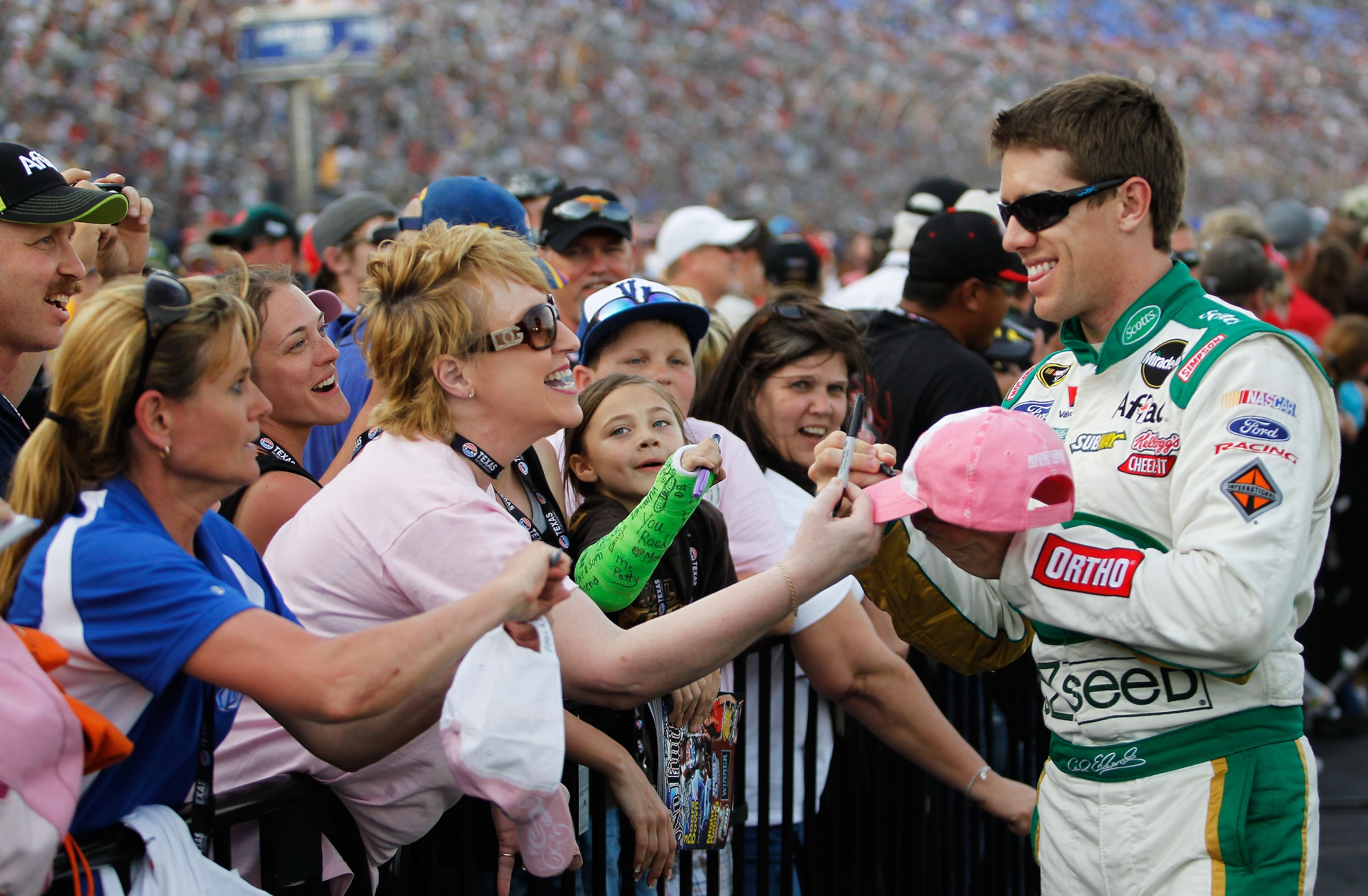 FORT WORTH, TX - APRIL 09:  Carl Edwards, driver of the #99 Scotts Ford, greets fans prior to the NASCAR Sprint Cup Series Samsung Mobile 500 at Texas Motor Speedway on April 9, 2011 in Fort Worth, Texas.  (Photo by Tom Pennington/Getty Images for NASCAR)