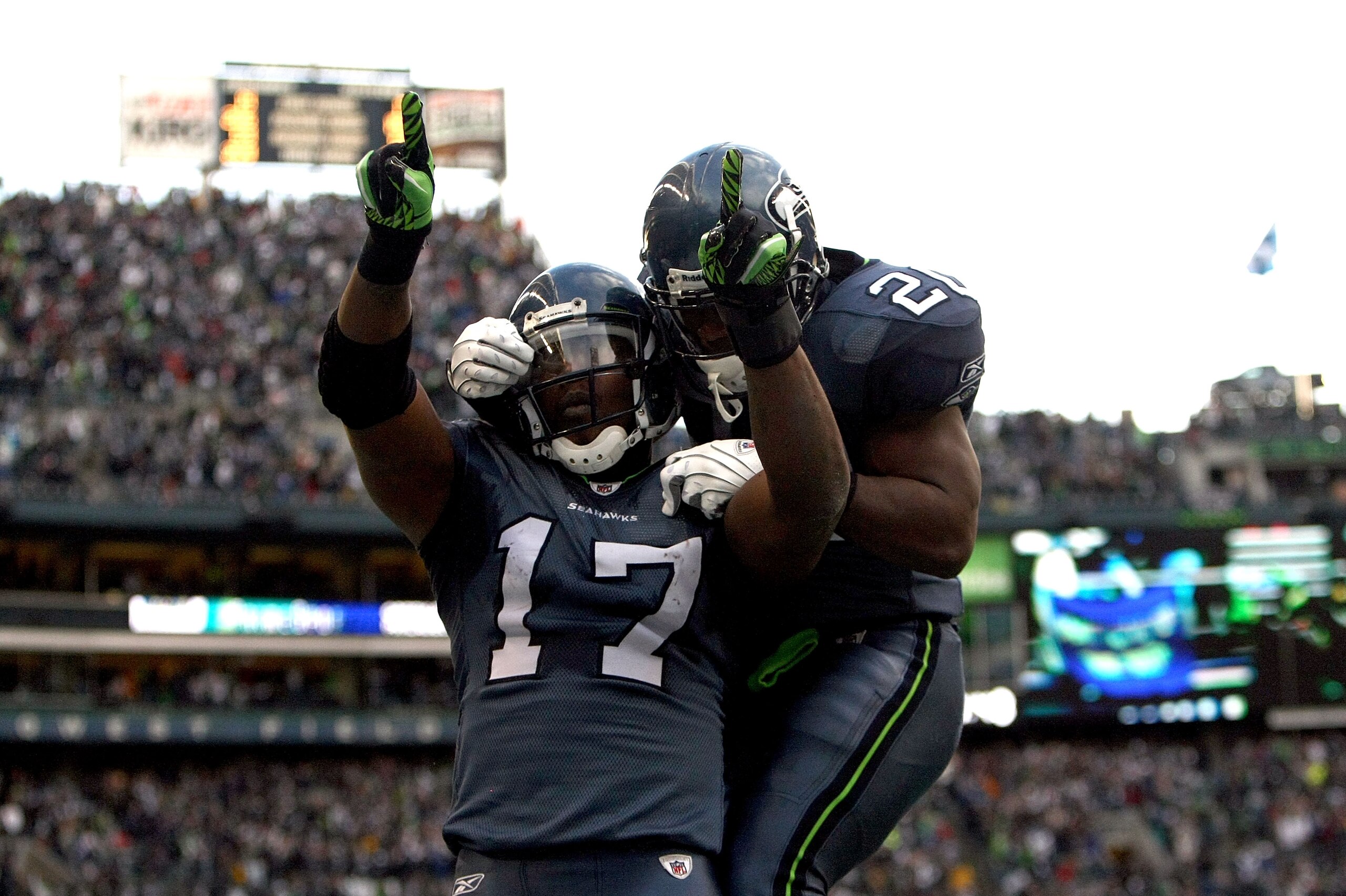 SEATTLE, WA - JANUARY 08: Wide receiver Mike Williams #17 of the Seattle Seahawks reacts with teammate Justin Forsett #20 after catching a 38-yard third quarter touchdown pass against the New Orleans Saints during the 2011 NFC wild-card playoff game at Q SEATTLE, WA - JANUARY 08: Wide receiver Mike Williams #17 of the Seattle Seahawks reacts with teammate Justin Forsett #20 after catching a 38-yard third quarter touchdown pass against the New Orleans Saints during the 2011 NFC wild-card playoff game at Q