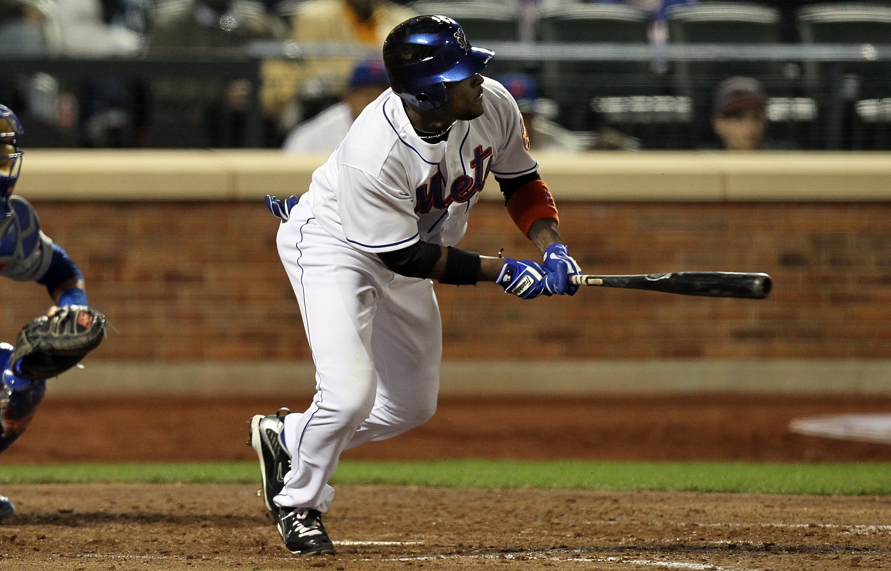 NEW YORK - APRIL 19:  Luis Castillo #1 of the New York Mets follows through on a 5th inning RBI infield single against the Chicago Cubs on April 19, 2010 at Citi Field in the Flushing neighborhood of the Queens borough of New York City. Players from both